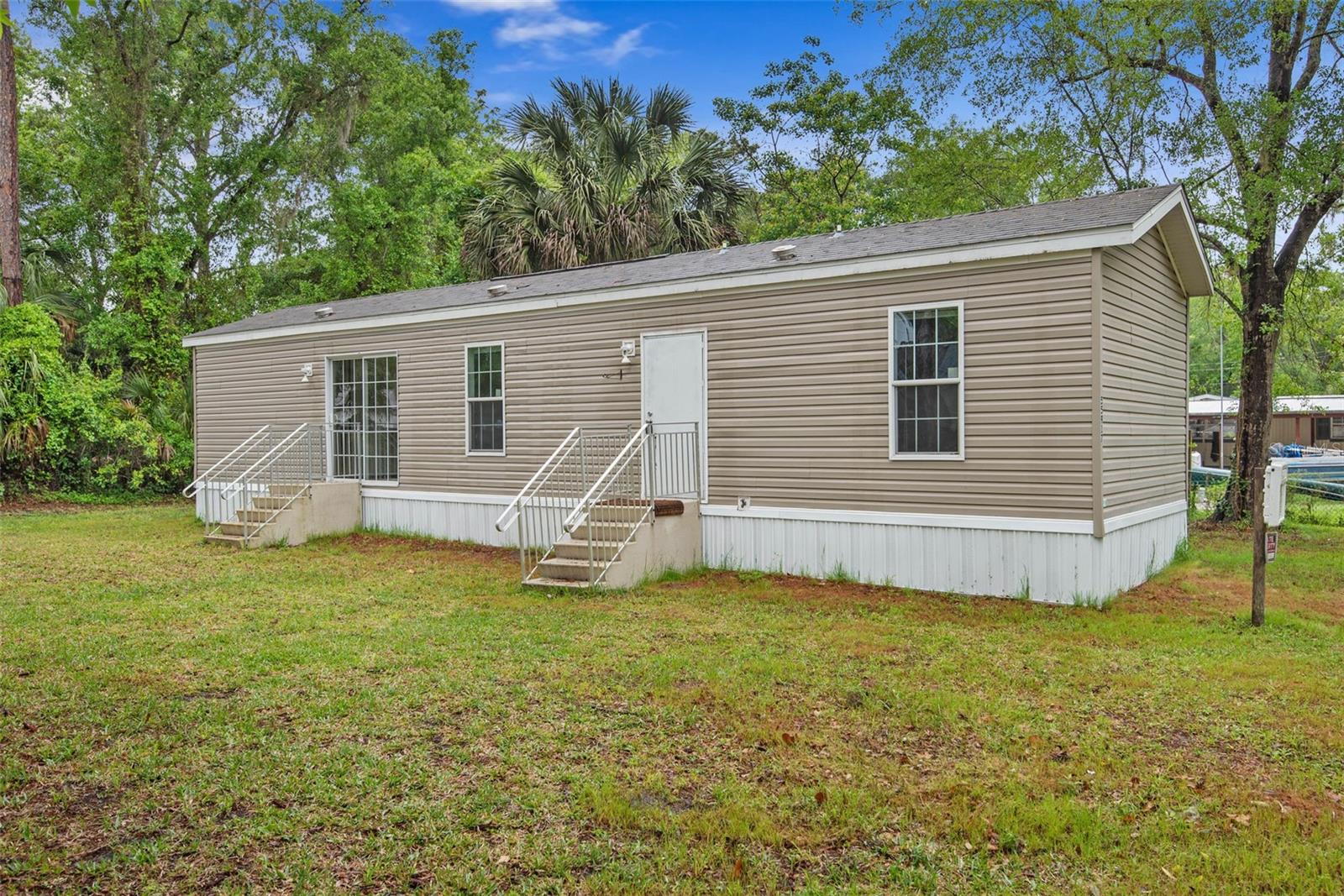BACK ON THE MARKET. Buyer financing fell through.

Welcome to your private slice of Old Florida charm at 55917 Cabbage Road in Astor! Nestled on a spacious lot surrounded by natural beauty, this property offers the perfect blend of tranquility, outdoor adventure, and laid-back living.

Located just moments from the St. Johns River, this home is a dream for boating, fishing, and nature enthusiasts alike. Enjoy peaceful mornings with coffee on the porch, listening to the sounds of wildlife, and unwind in the evenings with breathtaking sunsets beneath a canopy of mature trees.

Inside, you’ll find a comfortable and inviting layout with plenty of natural light, creating a warm and welcoming atmosphere. Whether you're looking for a full-time residence, weekend getaway, or investment opportunity, this home provides endless potential to make it your own.

With no HOA, ample space for your boats, RVs, and toys, and easy access to nearby parks, marinas, and local dining, this is true Florida living at its best.

Don’t miss your chance to own a piece of Astor’s hidden paradise—schedule your private showing today!