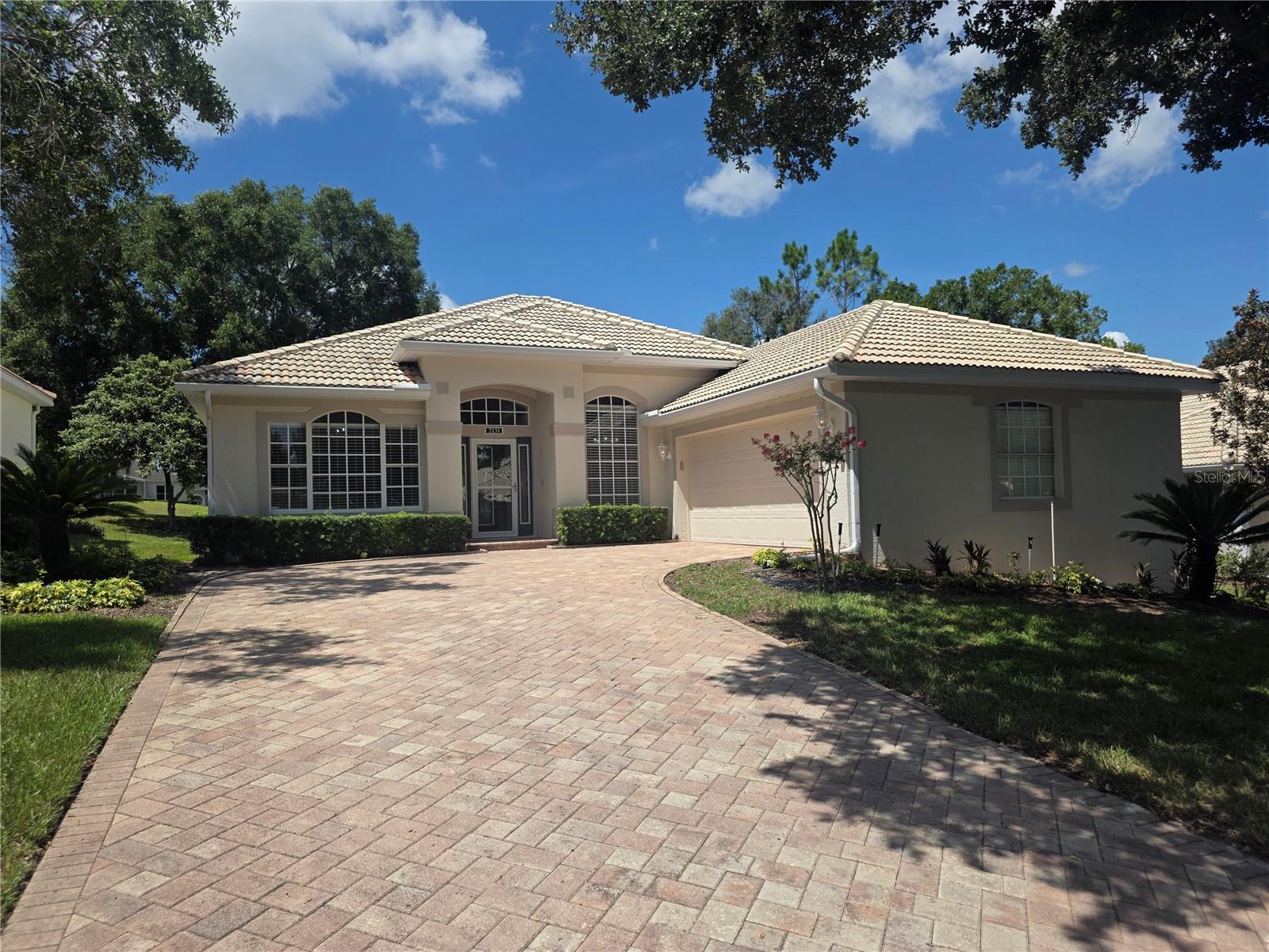 pro pics will be uploaded tomorrow. Discover a truly exceptional one-of-a-kind single-story golf course home located on the 8th fairway of the Championship Course in the highly sought-after 55+ gated community of Kings Ridge in Clermont, Florida. This former model home offers an upgraded version of the popular Kensington floor plan with thoughtful improvements, expanded living areas, and a premier location overlooking the beautifully maintained golf course.
Behind the 24-hour guarded entrance of Kings Ridge in the desirable village of The South Hamptons, this stunning residence welcomes you with a brick paver driveway leading to a side-entry two-car garage and an impressive leaded and beveled full-glass front door with matching side panels. Upon entering, you are greeted by a distinctive round decorative mosaic tile foyer and elegant ceramic tile flooring laid on the diagonal throughout the main living areas, creating an open and sophisticated feel.
The spacious 28-foot by 20-foot family room provides an ideal gathering space and flows seamlessly into the kitchen and dining area. Additional living space was created by enclosing the original lanai under air conditioning, adding valuable heated square footage to the home. Enjoy Florida outdoor living year-round in the expansive 36-foot by 12-foot screened porch featuring beautiful Chattahoochee rock flooring and peaceful golf course views. Therapy tub stays too.
The primary suite offers exceptional comfort with dual closets leading to a private owner’s retreat, complete with a relaxing garden bath and oversized walk-in shower. The thoughtful single-story layout provides convenience, accessibility, and effortless living.
Kings Ridge offers one of Central Florida’s premier active adult lifestyles with maintenance-free living and resort-style amenities. HOA benefits include 24-hour guarded security, escrow reserves, cable, internet, and complete lawn maintenance including irrigation, fertilization, and mulching. Residents enjoy access to a multi-million-dollar clubhouse featuring multiple pools, fitness centers, tennis, pickleball, basketball, shuffleboard, bocce ball, a grand ballroom, library, craft rooms, billiards, computer rooms, and card rooms.
Beyond the amenities, Kings Ridge provides an active social lifestyle with clubs, classes, entertainment, shows, dances, movies, and organized activities ranging from floral arranging to investing. Planned travel opportunities are also available for residents who enjoy exploring new destinations.
Conveniently located, Kings Ridge allows residents to drive their golf carts to nearby shopping, restaurants, banks, medical offices, hair salons, and everyday conveniences. The community features both an 18-hole Championship Golf Course and an 18-hole Executive Course, making it a true golfer’s paradise.
This beautifully maintained golf course home combines luxury, comfort, convenience, and the unmatched lifestyle of Kings Ridge in Clermont, Florida.