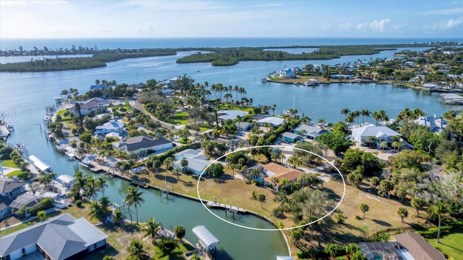 An exceptional Cape Haze waterfront retreat designed for serious boaters and avid anglers.
This incredible property offers 105 feet of deep-water canal frontage with a brand-new composite dock, 12,000-lb boat lift, concrete seawall, no bridges, and only approximately 600 feet to the Intracoastal Waterway. *Brand new impact resistant windows and sliders have just been installed. Positioned on the southernmost canal in Cape Haze, boaters enjoy immediate access to the world-class fishing waters of Charlotte Harbor, Gasparilla Pass, and the Gulf of Mexico. Set on a generous 0.68-acre lot, the home is tucked away in a quiet, secluded section of the historic Vanderbilt-developed neighborhood of Cape Haze, where streets are lined with majestic banyan trees. The wide canal allows easy maneuvering and docking for large vessels, making this an exceptional boating estate.  The classic 1960s Florida home blends charming retro elements—such as original terrazzo flooring—with an extensive 2025 top-to-bottom renovation. Updates include a beautiful new kitchen, fully remodeled bathrooms, impact-resistant windows and sliders, new pool cage, resurfaced swimming pool with new tile, new appliances, and updated mechanical systems.  The stunning bathrooms feature tiled showers, designer vanities, new plumbing fixtures, and framed mirrors. The kitchen is a showpiece with custom wood cabinetry, quartz countertops, stainless steel appliances, and modern fixtures—perfect for entertaining after a day on the water.  Located just minutes by car or boat to historic Boca Grande, pristine sandy beaches, essential shopping, fine dining, private Coral Creek Jetport, private and public golf courses, and several full-service marinas, this home offers the ultimate Southwest Florida waterfront lifestyle.
