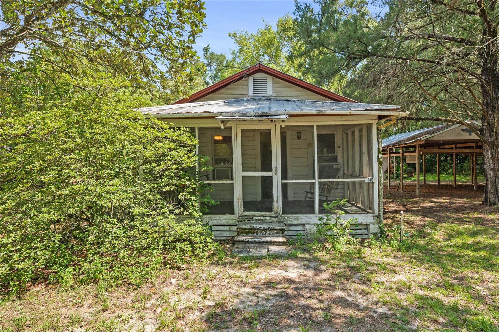 Opportunity awaits in this charming 1935 wood-frame home located in fast-growing Apopka! Situated on a generous 0.61-acre agriculturally zoned lot, this 2-bedroom, 1-bath "Fixer upper" home offers 640 square feet of living space and plenty of potential. Whether you're looking for a primary residence, investment property, a place with room to grow or to build your dream home, this unique property offers endless possibilities in a rapidly developing area. Relax on the screened porch and enjoy the privacy and flexibility of this spacious property. With no HOA, you'll have the freedom to park your boat, RV, or other recreational vehicles on-site.