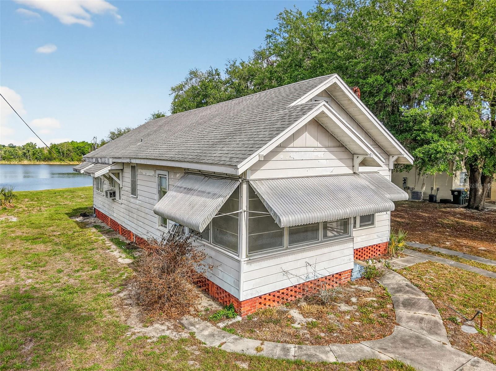 LAKEFRONT BUNGALOW IN UMATILLA – NEAR THE OCALA NATIONAL FOREST! Nestled on a generous .68-acre parcel along the shores of Lake Enola, this charming waterfront bungalow is truly as cute as a button and ready for your personal touch. Step inside to discover beautiful hardwood floors, vintage built-ins, and spacious rooms filled with character and warmth. This home offers the perfect canvas to create your own lakeside retreat, weekend getaway, or investment opportunity. Enjoy breathtaking sunsets across Lake Enola, a local favorite known for great fishing and fun water activities. Roof 2016, HVAC 2023.With its proximity to the Ocala National Forest, outdoor enthusiasts will love the easy access to hiking, springs, and nature adventures. The large lot offers potential for multiple dwellings (buyer to confirm with the City of Umatilla), making this a unique opportunity for expansion or multi-generational living. Whether you're looking for a peaceful lakeside lifestyle or a property with future potential, this one checks all the boxes. Bring your vision and make this waterfront gem your own!