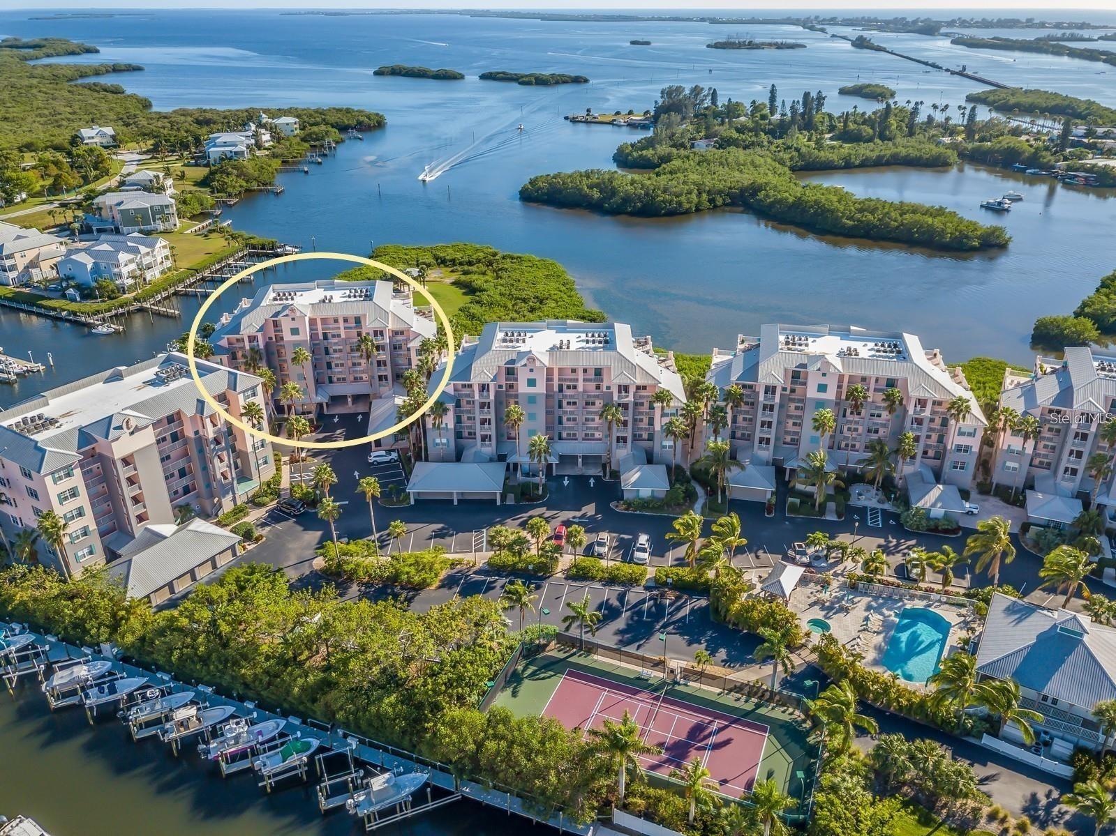 Beautiful waterfront condo featuring panoramic views of Gasparilla Sound and Boca Grande. This turnkey, fully furnished condo is an open-concept 2-bedroom, 2-bathroom, with a versatile space perfect for a den, office, or additional bedroom, with eat-in breakfast nook area and bar. The primary suite offers harbor views with a private access to the screened lanai, walk-in closet, en-suite bathroom with double sinks and spacious linen closet. Notable interior features include plantation shutters throughout and a roll-down hurricane shutter for the screened lanai, brand newly installed dishwasher, disposal, and refrigerator. The condo comes with a large private garage with plenty of storage space, located under the building on the end, providing a short walk to the kayak launch. Move-in ready for primary/seasonal residence or vacation rental. The Boca Vista Harbor complex is situated on Gasparilla Bay within a gated community that offers premium amenities, including a heated swimming pool, hot tub, poolside area BBQ grills, clubhouse, tennis/pickleball court, kayak and paddleboard launch area with nearby trails and access to boat docks and slips that may be available for rent and purchase. The property is conveniently located next to a full-service marina, a walkable ship store and a waterfront restaurant with live entertainment. Direct access to boating, fishing, kayaking, and paddle boarding. Just minutes from Gasparilla Island and Boca Grande. Only a 5-10 minute drive from the Boca Grande beaches.