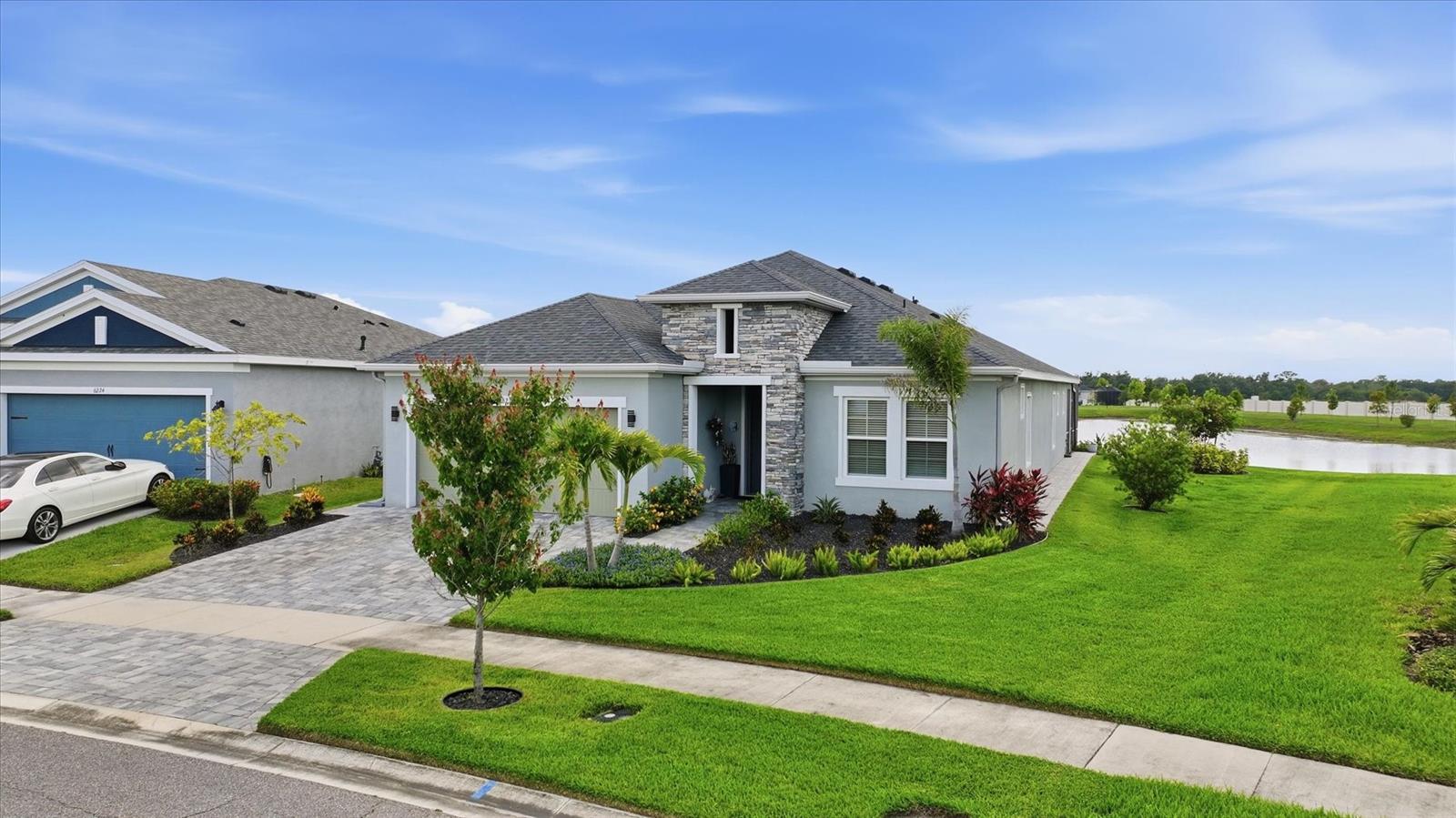 Welcome to this beautifully upgraded 2023 Cardel Southampton 2.0 in the highly sought-after Waterset community of Apollo Beach. Situated on an oversized lakefront homesite with approximately 90 feet of water frontage, this stunning home offers 4 bedrooms, 2 bonus/flex rooms, 3 full bathrooms, and 2,494 sq ft of thoughtfully designed living space. From the widened paver driveway and professionally upgraded landscaping to the expansive 40x18 screened paver lanai overlooking peaceful pond views, every detail was carefully selected for luxury and comfort. Inside, you’ll find upgraded tile flooring throughout with no carpet, upgraded quartz countertops in the kitchen and all bathrooms, upgraded cabinetry with soft-close drawers, double ovens, designer backsplash, Kohler sinks, upgraded fixtures, and a dramatic 12-foot center-opening sliding glass door that fills the home with natural light. The spacious primary suite features a custom Closets by Design walk-in closet and a spa-inspired bath with frameless glass shower enclosure and floor-to-ceiling tile. Additional highlights include two versatile bonus spaces perfect for a home office, gym, or media room, tankless water heater, water softener and filtration system, EV charging outlet, epoxy garage floors with cabinets and workbench, smart home features, ceiling fans throughout, and more. Located in one of Apollo Beach’s premier resort-style communities with pools, fitness centers, parks, trails, and convenient access to Tampa, beaches, shopping, and dining, this exceptional home is truly move-in ready and shows like a model.