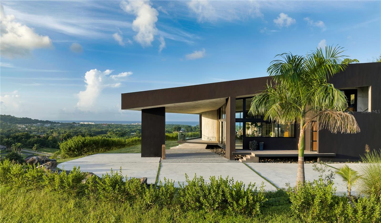 Set within the iconic Carabali equestrian destination, spanning over 600 acres of lush tropical landscape, this extraordinary estate offers a rare combination of ocean views, rainforest scenery, and unmatched lifestyle access. This 4,278 sq. ft. residence is uniquely positioned to capture breathtaking panoramic views of both the Atlantic Ocean and El Yunque rainforest, creating a daily living experience that feels both expansive and deeply connected to nature. Surrounded by horseback riding trails that lead through tropical landscapes and extend toward the beach. This property is ideal for those seeking a distinctive Caribbean lifestyle where privacy, adventure, and natural beauty converge. Whether envisioned as a private residence, luxury retreat, or investment opportunity, this estate delivers a setting that is simply irreplaceable. Located within Carabali’s 600-acre equestrian destination with access to horseback riding trails and nature. Enjoy stunning ocean and rainforest views of El Yunque. Now newly repositioned to reflect market opportunity, inviting immediate interest from discerning buyers worldwide.