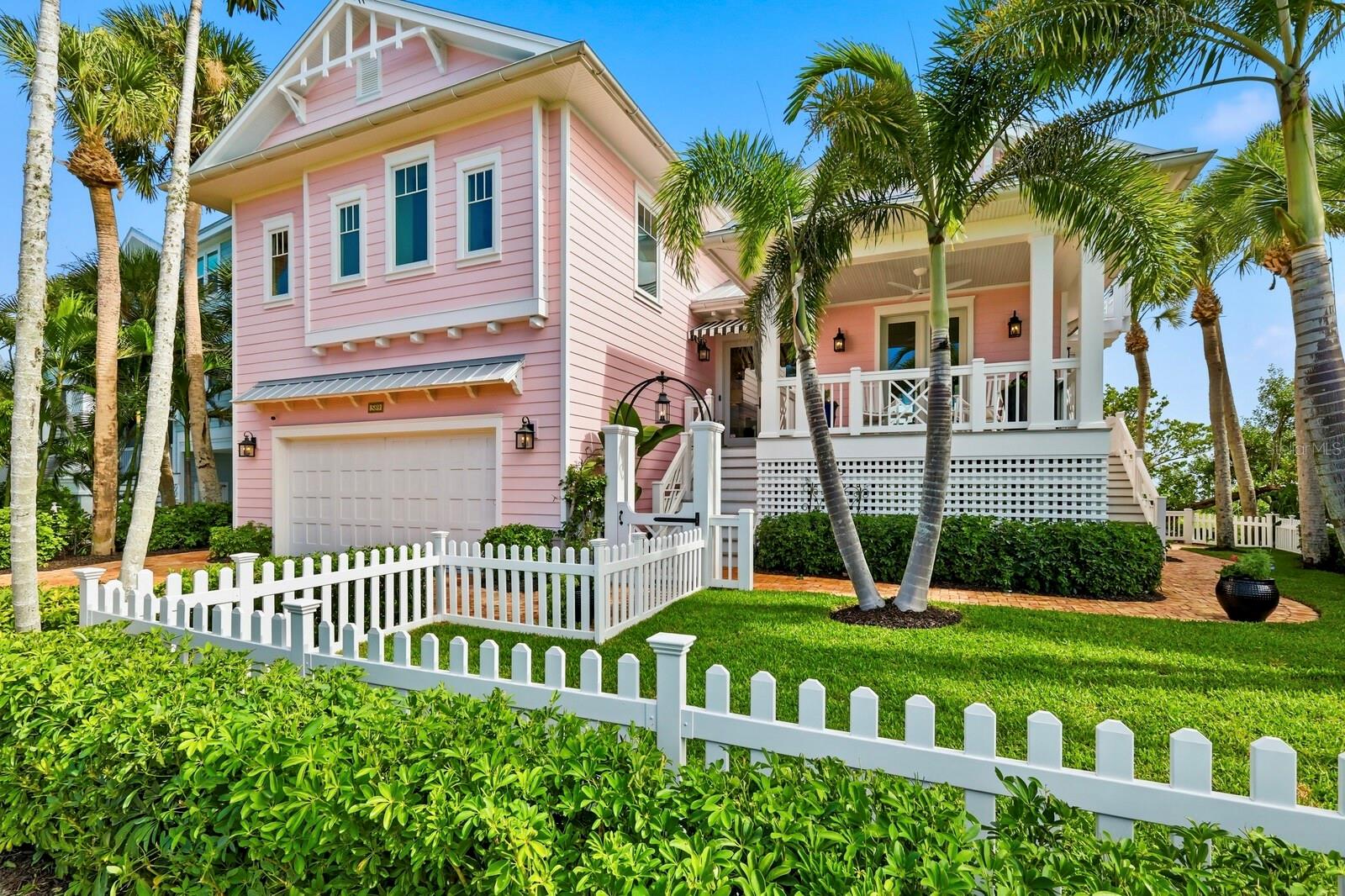 Welcome to “The Pink House,” a signature bayfront residence quietly tucked along the shoreline of the South Bay neighborhood within Boca Bay. Offering 3 bedrooms and 3.5 bathrooms, this home was thoughtfully re-designed and extensively renovated in 2014 to provide an elevated coastal living experience defined by sweeping water views, relaxed indoor–outdoor flow, and uncompromising attention to detail.
Set on one of the larger parcels within the neighborhood, the property enjoys substantially more water frontage than most South Bay homes—enhancing both privacy and the immersive connection to the bay. Equally rare, the fully fenced front and side yard areas create generous outdoor living, garden, and play spaces while maintaining a natural harmony with the surrounding coastal landscape.
The home’s preferred waterfront orientation captures panoramic views across the bay from nearly every living space—framing shifting tides, morning light, and unforgettable evening color. A standing seam metal roof (2013), impact-rated windows and doors, HardiePlank siding, Ipe decking, and Chicago brick pavers together form a refined exterior aesthetic that marries beauty with long-lasting durability.
Inside, the atmosphere is warm, bright, and intentionally curated. The kitchen is outfitted with Sub-Zero refrigeration (including a full Sub-Zero wine column), a Wolf 6-burner range, and handcrafted cabinetry—creating a space equally suited for relaxed coastal evenings and gracious entertaining. Haiku fans and custom lighting elevate the home’s understated sophistication.
A private expanded dock, complete with two boat lifts and an appealing seating area invites effortless access to the surrounding water, renowned for world-class fishing, scenic cruising, and limitless saltwater exploration.
As a resident of Boca Bay, you’ll enjoy exclusive access to the Pass Club, where waterfront dining, Har-Tru tennis courts, fitness facilities, and beach access extend the experience of island living. Additional community amenities include multiple swimming pools, pickleball courts, short-term boat dockage, a private fishing pier, and a Gulf-front Beach Club.
“The Pink House” is more than a residence, it is a rare opportunity to experience Boca Grande’s most cherished coastal lifestyle, where thoughtful design, natural beauty, and a sense of ease come beautifully together.