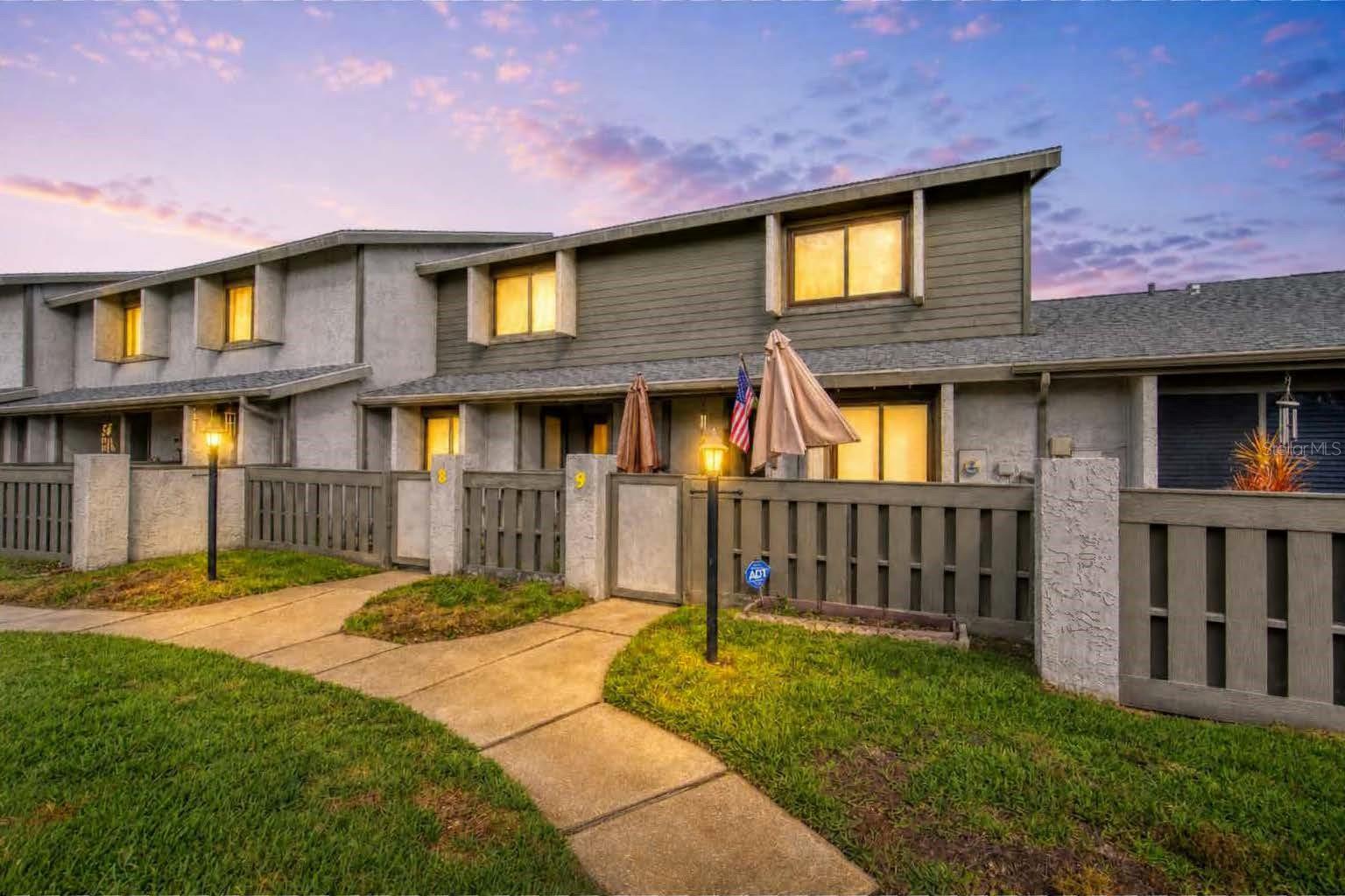 One or more photo(s) has been virtually staged. This charming 2-story townhome in Lakes of Pine Run offers peaceful lakefront living with tranquil water views from both levels. The inviting living room features a cozy wood-burning fireplace and French doors that open to a screened lakefront lanai, the perfect spot to enjoy your morning coffee while watching turtles swim by. The updated kitchen boasts granite counters, white cabinetry, stainless steel appliances, and an eat-in nook, making meal prep and casual dining a pleasure. Upstairs, the primary suite overlooks the lake and includes an en-suite bath with a walk-in shower, creating a private retreat. A second bedroom and full guest bath on the same level provide comfortable accommodations for family or visitors. Additional conveniences include a first-floor laundry area, half bath, extra storage room, and one assigned covered parking space. Practical updates such as a newer HVAC system and fresh interior paint add extra peace of mind and a move-in-ready feel. Residents of Lakes of Pine Run enjoy a low-maintenance lifestyle with access to a community pool, as well as tennis and pickleball courts, all just a short drive from Ormond Beach’s shops, dining, parks, and sandy beaches