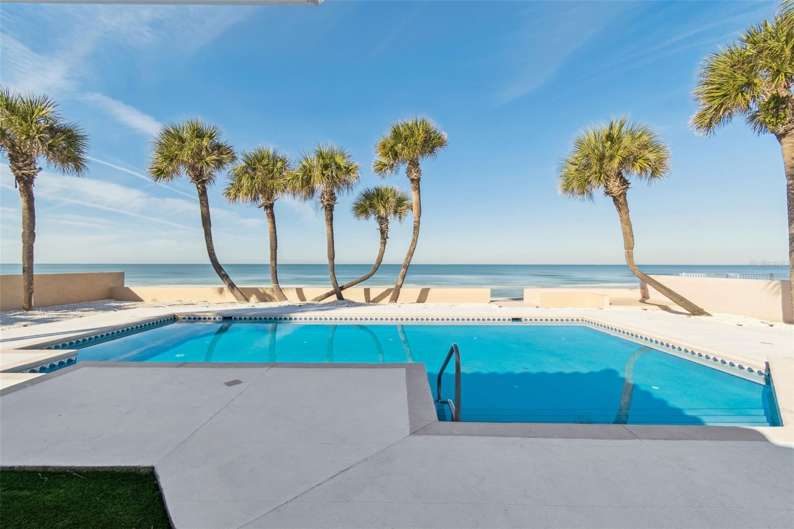 An extraordinary opportunity to own a premier beachfront estate in the highly sought-after community of Belleair Beach. Positioned directly on the pristine sands of the Gulf of Mexico, this expansive 80-foot-wide by 259-foot-long beachfront lot offers breathtaking panoramic water views, nightly sunsets, and endless potential to create a custom luxury estate tailored to your vision. The existing 9,069 total square foot residence can absolutely be enjoyed as-is, renovated, or serve as a placeholder while planning your future beach house. This estate boasts 6 bedrooms and 5 full baths and 2 half baths. Designed for entertainment, the gourmet kitchen is a chef's delight. Featuring state-of-the-art appliances, wood cabinetry, and a spacious island with cooktop and hood, all perfect for culinary creations. Entertain in the oversized formal dining room or the formal living room. You and your guests will love spending time in the large upstairs game room and full bar. Retreat to one of the two lavish primary suites, one downstairs and one upstairs. Wake up to the sound of waves gently crashing against the shore. Outside, a private oasis awaits, an oversized resort style sparkling pool and covered deck with direct access to the 80 feet of white sugar sand beachfront deeded extending beyond the seawall which leaves room beachside for chairs or even jet skis. This property offers true Gulf-front ownership—ideal for long-term investment or redevelopment. Set behind private gates, the property provides exceptional privacy and generous land footprint—an increasingly rare find along the Gulf Coast. The large lot size allows for the construction of a substantial future residence, offering ample space for a grand custom home with resort-style amenities, expansive outdoor living areas, and direct beach access. Whether your vision includes multiple levels, generous square footage, a pool and spa, or expansive terraces overlooking the Gulf, this property offers the flexibility to build at scale. Located on Belleair Beach and just minutes from Clearwater Beach and Indian Rocks Beach, you will enjoy close proximity to world-class dining, shopping, and vibrant entertainment while maintaining the tranquility and exclusivity Belleair Beach is known for. Beachfront lots of this size and caliber are increasingly scarce. 1520 Gulf Blvd represents a rare opportunity to secure an irreplaceable piece of Gulf-front land with unlimited future potential. Schedule a private tour today to explore the possibilities.