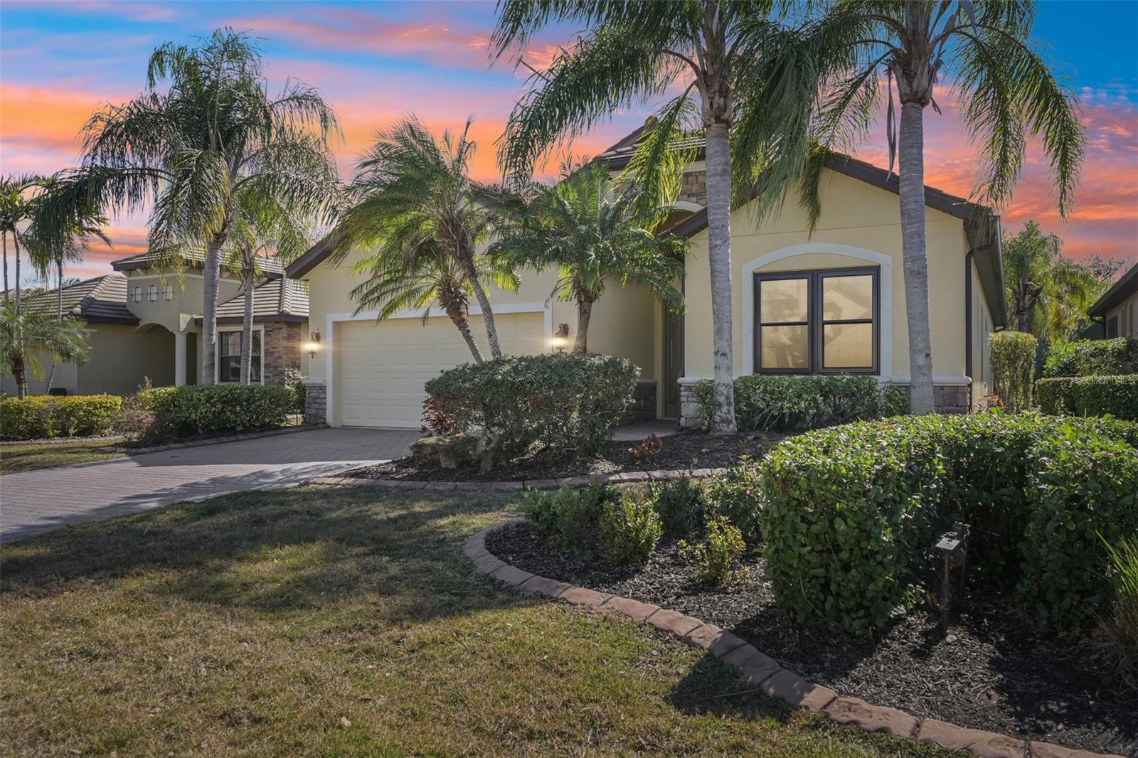 PRICE IMPROVEMENT! Seller has reduced the price by $25K and is offering $25K towards buyer’s closing costs.
Refined Florida living meets resort-style comfort in this former model home designed for both everyday ease and elegant entertaining.

This exceptional residence offers two bedrooms plus a versatile den with built-in desk and custom shelving, and two full bathrooms, all thoughtfully finished with high-end details throughout. A grand entryway welcomes you with soaring ceilings accented by crown molding and elegant coffered ceilings, while wood and tile flooring flow seamlessly through the living spaces, creating a warm yet sophisticated feel. The eat-in kitchen is both stylish and functional, featuring quartz countertops, tall cabinetry, a stone backsplash, and newer stainless-steel appliances—including a wine refrigerator. A charming window seat beneath the bay window adds the perfect spot for morning coffee or casual dining. The primary suite is a private retreat with two walk-in closets and a well-appointed bathroom offering granite countertops, 2 sinks, and a walk-in shower. Step outside to the screened lanai and enjoy true indoor-outdoor living with hurricane-impact windows, a heated saltwater pool with fountain, expansive deck, fire pit, and a freestanding hot tub—ideal for relaxing or hosting guests year-round. Additional highlights include a full laundry room with storage, a two-car garage with additional storage, generous living spaces, and exceptional attention to detail throughout. A truly special home that blends comfort, style, and functionality in every space.