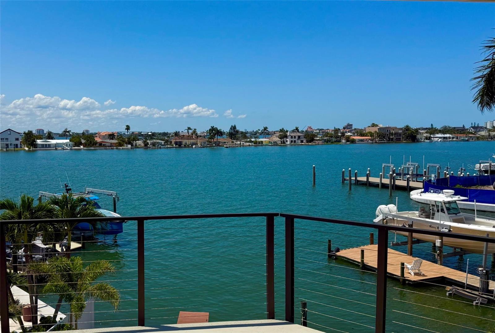 “WALK TO THE BEACH OR JUST STAY HOME AND ENJOY THE VIEWS OF BOCA CIEGA BAY.”
This exquisite custom waterfront residence features 4 bedrooms and 3-1/2 bathrooms, complemented by a 2-plus car garage. It offers approximately 2,900 square feet of air-conditioned interior space, along with an additional 1,000 square feet of outdoor deck space featuring Pli-Dek flooring. The home is like-new and move-in ready condition having gone through a complete down to the studs renovation in 2023/24. All electrical and plumbing systems have been newly installed, and the HVAC system has been upgraded. An abundance of windows, including motorized shades, provides a water view from every room, as well as an unobstructed view of the classic Don Cesar Hotel. The residence is equipped with a tankless hot water heater that includes recirculating lines, ensuring immediate access to hot water. Wind mitigation measures have been implemented, including a Hardie board exterior, tile roof, Pella hurricane-rated sliding doors and windows, stud strapping and shear walls. The first floor is lined with cement backer board on all walls. Additionally, a 22KW Whole House Generac generator is connected to a 500-gallon underground propane tank. The wood-burning fireplace has been renovated, professionally sealed and features a new chimney cap and fireplace doors. The luxurious owner’s suite offers a spa-like bathroom with water closet and over-sized soaking tub, separate his and her walk-in closets and 10-foot glass doors overlooking Boca Ciega Bay. The home includes a three-stop oversized elevator and an open floor plan that is ideal for entertaining. All new exterior highlights include a heated and cooled custom salt-water pool with champagne spa and sun-shelf, a travertine deck and covered lanai, lush tropical landscaping, an oversized driveway with guest parking, sprinkler system, video surveillance, privacy fence, and a raised seawall. The property is situated on an exceptional lot in the upscale Bahia Shores on St. Pete Beach, providing easy access (a 10-minute walk) to a nationally top-ranked sugary white sand beach, epitomizing luxury resort-style living. Furnishings are negotiable. The buyer to confirm square footage.