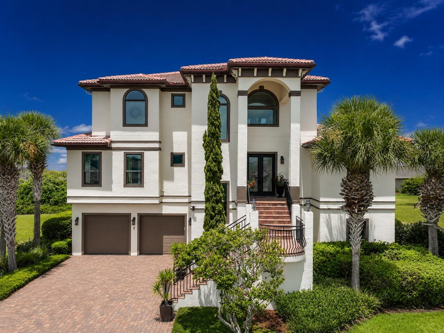 Experience the pinnacle of "Coastal Luxury" in this extraordinary lakefront estate offering breathtaking
ocean views (3rd floor) and an exceptional blend of timeless elegance and modern sophistication. This
meticulously maintained five-bedroom residence showcases an open-concept design filled with
natural light, soaring ceilings, and exquisite finishes throughout. The chef-inspired gourmet kitchen
is a culinary masterpiece featuring a large center island with prep sink, 5-burner gas cooktop,
double ovens, warming drawer, wine chiller, workstation, and breakfast nook, seamlessly flowing
into spacious living and dining areas designed for effortless entertaining.

The first-floor entertainment space is complete with a wet bar, refrigerator, and ice maker, opening
to your own private TROPICAL RETREAT with a summer kitchen, sparkling SALTWATER POOL,SPA, and
beautifully designed outdoor living areas. A  PRIVATE ELEVATOR provides convenient access to all
levels, including the spectacular third-floor owner's retreat, where an expansive primary suite,
private balcony, and breathtaking sunrise views create the perfect sanctuary. The luxurious primary
bath offers separate his-and-her vanities, an oversized soaking tub, a walk-in shower, and an
adjacent loft ideal for a home office, library, or private sitting room.

This exceptional residence has been thoughtfully enhanced with PREMIUM UPGRADES, including 
2024 tankless water heater, 2024 third-floor HVAC system, two additional HVAC systems installed
in 2021, a brand-new kitchen refrigerator, designer kitchen backsplash, custom fireplace accent
wall, remodeled third-floor bathroom, professionally refinished kitchen cabinetry, elegant outdoor
lighting (2025), third-floor flooring (2023), epoxy garage floor (2024), outdoor grilling area (2024),
and comprehensive pool equipment updates completed between 2023 and 2025.

Perfectly positioned in one of Palm Coast's most desirable luxury communities, this remarkable
home offers an extraordinary opportunity to enjoy refined coastal living with unmatched comfort,
style, and craftsmanship. Every detail has been carefully curated to create a residence that is
equally suited for grand entertaining and everyday elegance.

An exceptional offering where refined elegance, spectacular views, and resort-style
amenities come together to create one of Palm Coast's finest luxury residences.