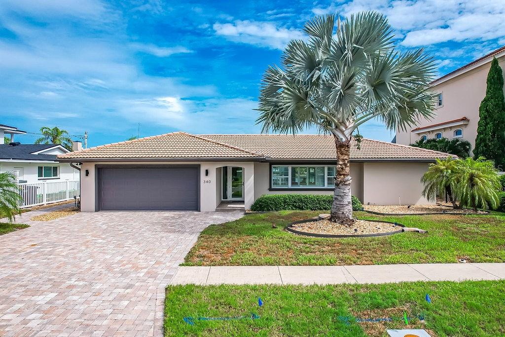 Experience luxury waterfront living in the highly sought-after Island Estates community. This beautifully renovated residence showcases exceptional craftsmanship and designer finishes throughout, including large-format porcelain tile flooring, a stunning chef's kitchen featuring a premium ILVE dual-fuel range with double ovens, quartz countertops, custom cabinetry, and an oversized island perfect for entertaining. The spa-inspired bathrooms offer frameless glass showers, floor-to-ceiling designer tile, pebble stone shower floors, and upscale fixtures. Enjoy an open-concept floor plan filled with natural light, spacious bedrooms, modern lighting, impact-rated windows and doors, and seamless indoor-outdoor living with direct access to the pool and waterfront. Complete with a private dock, this home is ideal for boating enthusiasts and those seeking the ultimate Florida waterfront lifestyle. Located just minutes from Clearwater Beach, restaurants, shopping, and all that Island Estates has to offer.