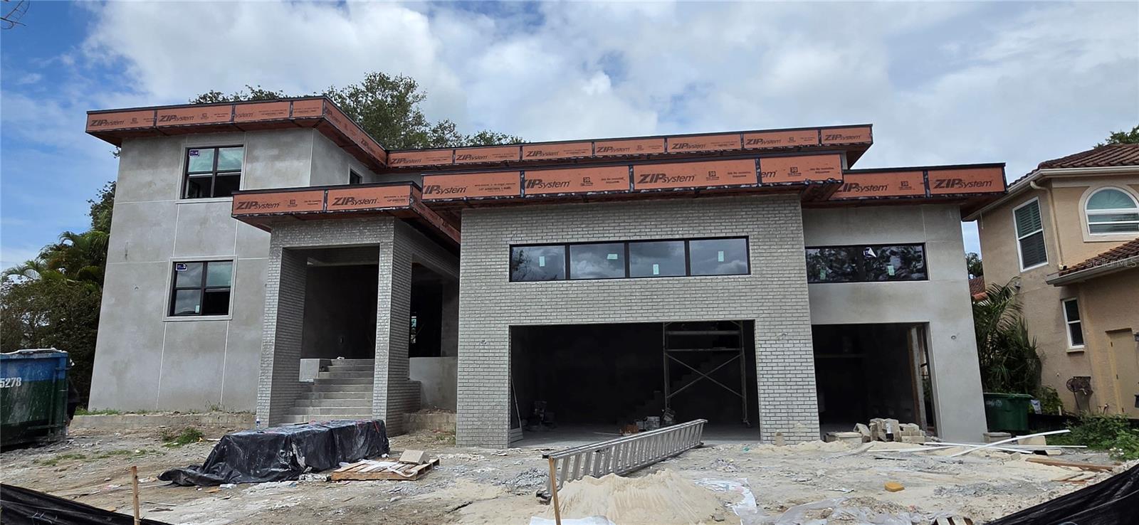 Under Construction. This masterfully crafted custom home offers 5,331 sf of air-conditioned living space, anchored by a first-floor primary suite and waterfall staircase with glass railing. The layout includes 6 bedrooms and a den. One bedroom could be a flex space suited for a gym, media room, or bonus room. The home offers 6 full baths, a half bath, plus pool bath, with upstairs and downstairs laundry rooms. The first floor is finished out with beautiful, large-format imported Spanish tile. The gourmet kitchen is built around a Viking 48" induction range with brass accents, paired with a full Viking appliance suite including column refrigerator and freezer, convection drawer microwave, and integrated dishwasher. Cabinetry features walnut lowers with glass-front walnut uppers in charcoal accents, a natural walnut refrigerator wall, and a charcoal island topped with premium collection luxury quartz. Haute Frank Lloyd Wright fixtures by Brizo in Luxe Gold, a 36" workstation sink, pot filler, and travertine surround complete the space. The great room features a custom walnut built-in with a 52" Modern Flames electric fireplace coupled with the adjacent parlor with a dry bar with a built-in Viking 24" wine column and patina brass chandelier. The primary bathroom retreat offers a walk-in shower with 67" freestanding soaking tub, draped with chevron tile floors, a 21" Frank Lloyd Wright Brizo rainhead, and dual walnut vanities — all finished in polished nickel and teak wood hardware. Every secondary bath carries its own distinct tile and finish story. Outside, on the spacious lanai, a fully equipped outdoor kitchen — Blaze 32" propane grill, outdoor fridge, drop-in sink, and custom 42" vent hood — anchors the entertaining space alongside the beautiful in-ground pool on a large lot, great for entertaining family and friends! Located on beautiful Davis Islands, enjoy walkability and golf-cart access to village shops and dining, waterfront parks, bike paths, tennis courts, dog parks, marina, beach, and the historic public pool—just minutes to Downtown Tampa, Water Street, Sparkman Wharf, Tampa General Hospital, and the Riverwalk, with convenient access to Tampa International Airport.
