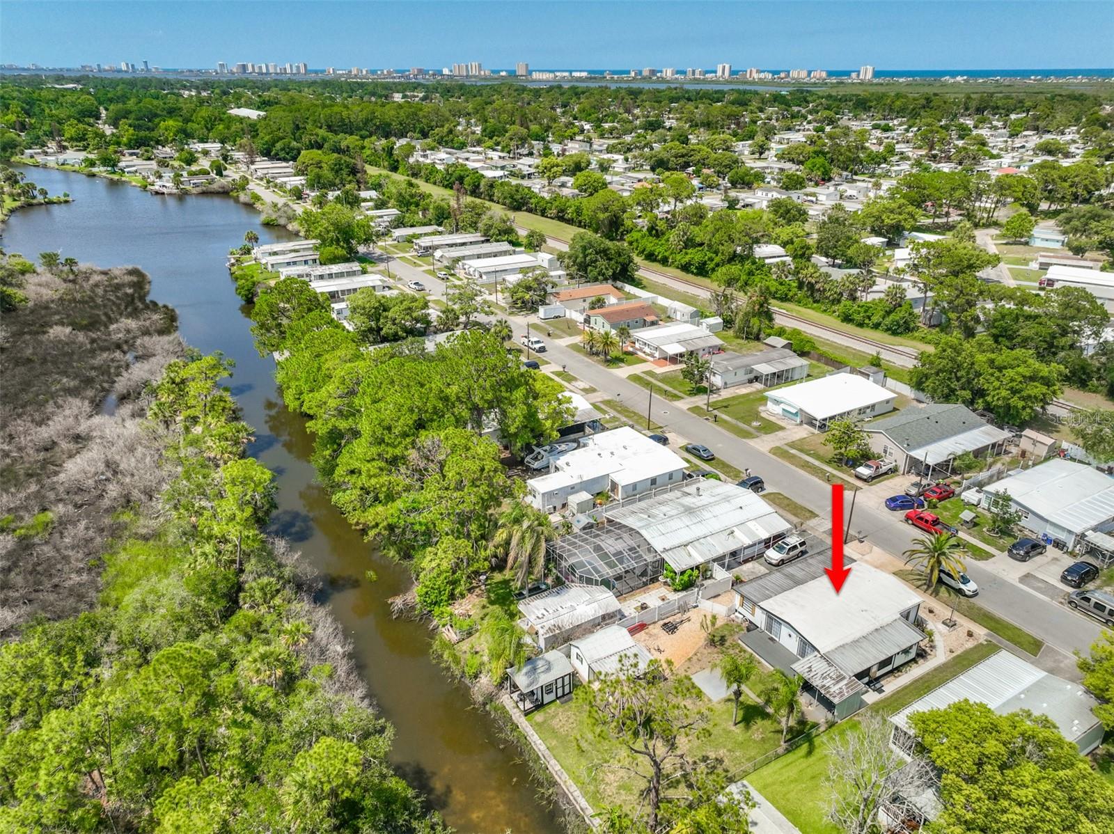 Water-front living under $250,000, and no HOA and no lot rent! You own the land. This fully-remodelled, canal-front home offers a Florida lifestyle with back yard privacy. 3 roomy bedrooms with a large, open living/kitchen/dining floorplan, makes this home perfect for everyday living, vacation home, or Airbnb (just minurtes to the beach). The kitchen has tons of cabinets, pantry, large island, granite counter tops, and newer stainless appliances. The master bedroom has a private bath and two closets. Vinyl plank flooring throughout - no carpeting! It would be so easy to entertain large groups of family and friends with two new sliders opening up to a new, weather-proof deck, a covered patio, and an open patio, perfect for a fire pit. A large shed can house all your toys and tools. An adorable ''man cave'' with a front porch is located right on the canal, offering the opportunity to fish all day and night, or just enjoy all the nature this property offers.

Additional parking is located along the North part of the home, and has a double gate for access to the back yard where you can store your kayaks, or other small watercraft. New irrigation system in front and back for easy lawn care.

The layout of the property inside and out offers the perfect Florida lifestyle, at an affordable price. You'll want to spend every day outside in your private back yard retreat.

Port Orange is close to shopping, dining, the beach, medical facilities, and has some of the best schools around.