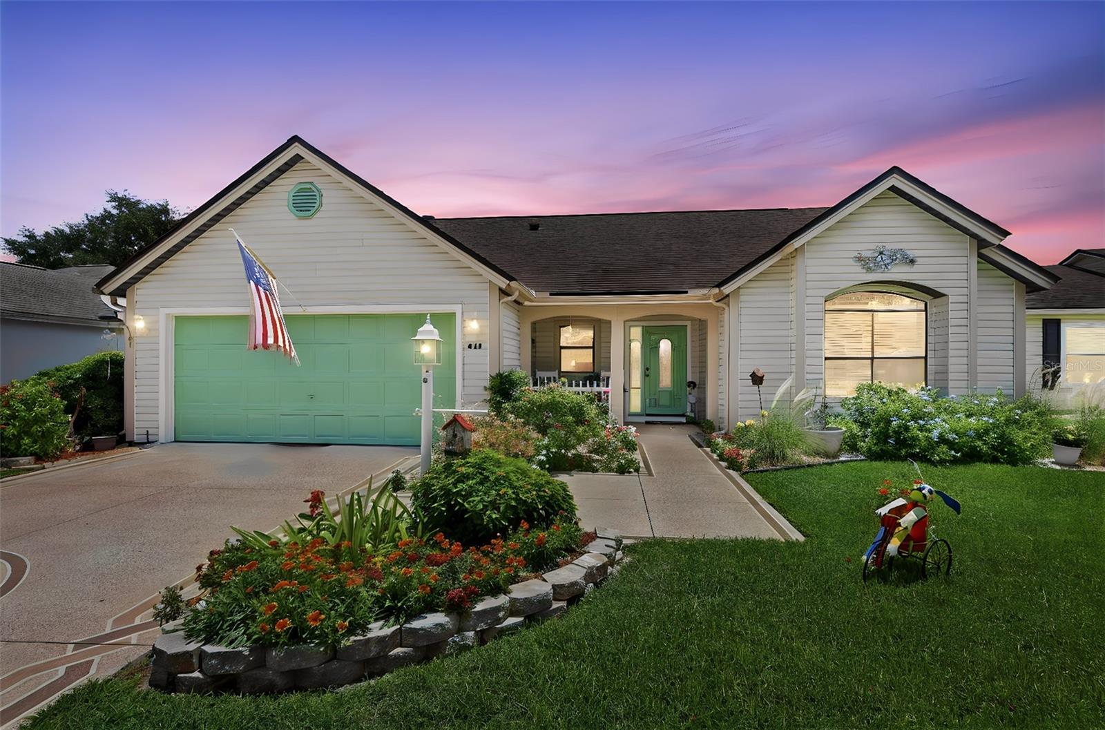 Welcome to 611 Lisbon Lane, a spacious and beautifully refreshed 2-bedroom 2-bath home offering an impressive 1,721 square feet in the heart of The Villages. Perfectly positioned between Spanish Springs Town Square and Lake Sumter Landing, this move-in-ready residence offers comfort, convenience, and exceptional everyday livability. Even better, the bond is paid, potentially saving the next homeowner thousands compared to homes with an outstanding bond balance.
Inside, you’ll find a bright and open 20' x 27' living and dining area designed for gathering, relaxing, and entertaining. Recent improvements include new flooring, HVAC, water heater, washer, dryer, dishwasher, microwave, and fresh interior paint. The kitchen features painted cabinetry, granite countertops, and a functional layout that flows easily into the main living spaces.
The enclosed Florida room, complete with newer windows, adds valuable flexible living space and is ideal for a TV room, dining area, hobby space, reading room, office, or comfortable guest overflow. The oversized primary suite measures approximately 13' x 22' and offers plenty of room for a king-size bed, nightstands, and a sitting area. Two walk-in closets provide excellent storage, with one currently arranged as a convenient office nook. The remodeled primary bathroom features a tiled shower with seat, dual-sink vanity, and separate water closet. The guest bedroom is generously sized with a large closet, and the guest bath has also been tastefully refreshed.
A separate interior laundry room with a new washer and dryer is a standout feature, offering added convenience and keeping laundry out of the garage, unlike many 2-bedroom homes in The Villages. Outside, enjoy morning coffee from the covered front porch, plus a private-feeling backyard framed by mature hedges that provide natural screening and shade along the rear exterior.
Located close to shopping, dining, medical services, Spanish Springs Town Square, La Plaza Grande, the new Aldi location, and UF Health Spanish Plaines Hospital, this home places everyday conveniences within easy reach. The Villages Community Watch also provides routine neighborhood presence. Furniture and golf car are available separately, making this a wonderful opportunity to move right in and start enjoying The Villages lifestyle.