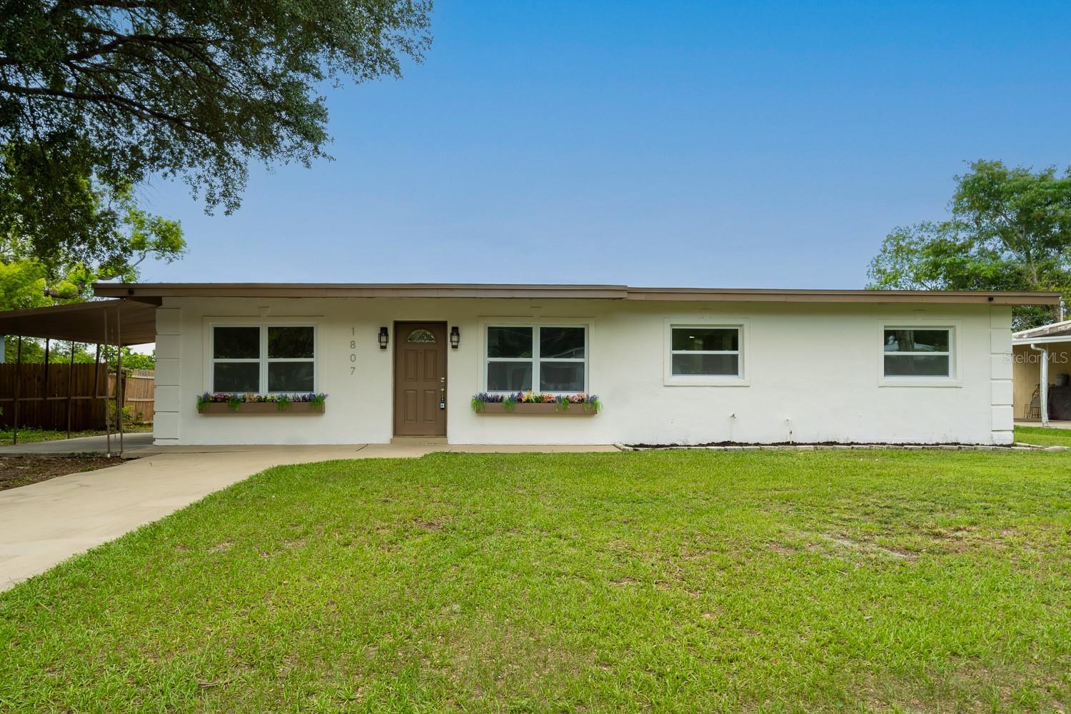 Virtually Staged. A fresh take on Orlando living, this fully renovated 4-bedroom, 2-bath home delivers style, MAJOR upgrades, and a convenient downtown-area location — all with NO HOA. From the moment you arrive, the home offers standout curb appeal with fresh exterior paint, all new windows, oversized 8-foot flower boxes, a palm tree in the front yard, and a freshly painted driveway.

Inside, the home has been thoughtfully updated from top to bottom with a bright modern layout, 7MM luxury vinyl SPC flooring, all-new lighting, fresh interior paint, new drywall, new baseboards, new door and window trim, new interior and exterior doors, and new hardware throughout. The BRAND-NEW kitchen features quality shaker cabinets, sparkling quartz countertop, gold accents, and a full new appliance package, creating a clean and stylish space that feels move-in ready from day one.

The primary bathroom is one of the true highlights of the home, designed with a spa-inspired feel, luxury soaking tub, double-sink vanity, large-format porcelain tile, and elegant modern finishes. Major updates provide added confidence, including a new roof completed in March 2025, brand-new HVAC system, updated electrical throughout, new plumbing fixtures, and a brand-new hot water heater. Enjoy a covered carport/patio area, oversized laundry/pantry right off the kitchen, peaceful water view, and easy access to Downtown Orlando, the Kia Center, dining, entertainment, shopping, and major roadways. A beautifully updated Orlando home with the big-ticket items already done — ready for its next owner.