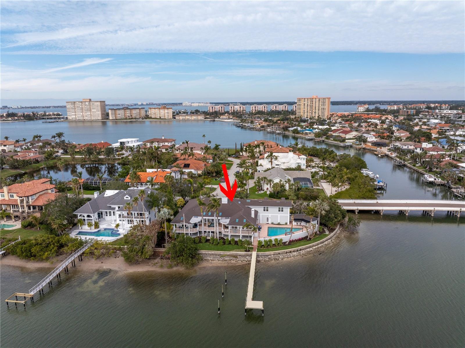 Coastal Elegance Meets Modern Durability in Bayway Isles
Discover the epitome of waterfront living in Bayway Isles, one of Tampa Bay's most prestigious gated communities. This Bahamian-style Colonial home blends timeless sophistication with modern upgrades, offering stunning views of Boca Ciega Bay and the iconic Skyway Bridge.
From the moment you arrive, the property captivates with its dramatic circular drive, fresh landscaping ($40K investment), and a grand covered double-door entry. Inside, the home exudes warmth and luxury, featuring five bedrooms, including a private in-law suite, and five full and one half baths. A private, wood-paneled office with brand-new wood floors and a new door offers a tranquil workspace, while the dining area’s recent updates add to the home’s refined character.
The chef’s kitchen is a culinary dream with granite countertops, a center island, and a breakfast bar that seamlessly connects to the family room. Every window frames breathtaking water views, enhancing the sense of serenity throughout. The expansive first-floor master suite offers private access to the outdoors, 250 feet of seawall, and unparalleled waterfront views.
Step outside into your personal oasis, complete with a sparkling pool, new swings, and meticulously manicured gardens. The spacious outdoor decks and private beach are perfect for launching a kayak or paddleboard, while the 2021-built dock—featuring water and electric hookups—can accommodate a large boat.
Safety and durability are paramount: this home, situated on elevated ground with a low flood insurance premium, withstood Hurricanes Helene and Milton without any damage or insurance claims. Hurricane shutters, Roll-a-Guard systems, and FEMA-compliant construction ensure peace of mind.
Bayway Isles offers convenient access to the Gulf Beaches, downtown St. Petersburg, and I-275. For boating enthusiasts, the property provides deep-water access with no bridges to the Gulf of Mexico.
Don’t miss this extraordinary opportunity to own a coastal retreat that embodies both elegance and resilience. Schedule your private showing today and experience the best of waterfront living!