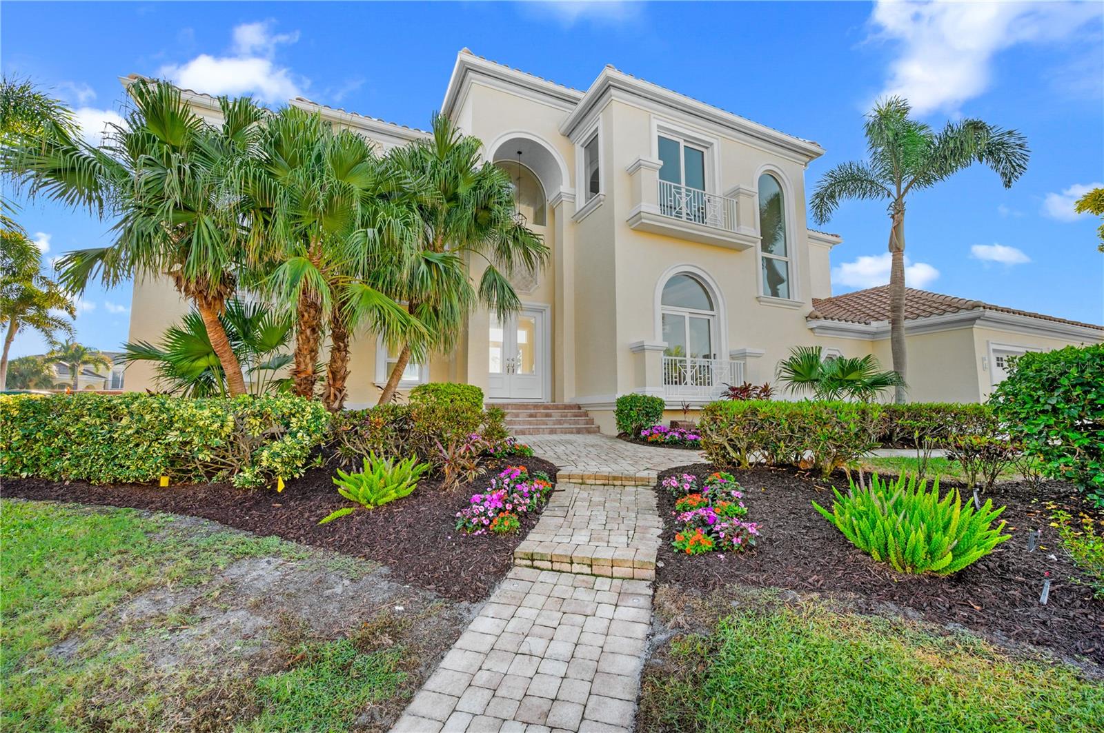 Experience elevated coastal living in this updated, elegantly styled waterfront residence in the coveted community of Country Club Shores on South Longboat Key. This beautifully maintained home has no history of flood or storm-water damage and offers peace of mind with a brand-new roof, all-new seawall, new dock, two boat lifts, updated mechanicals, and a private elevator—creating a true turn-key waterfront opportunity.  Inside, soaring vaulted ceilings and walls of glass frame sweeping bay views throughout the bright, open living spaces. The thoughtfully designed floorplan includes both formal and casual areas, featuring a living room, dining room, spacious family room, and an eat-in gourmet kitchen with high-end appliances—ideal for effortless entertaining. In addition to the main primary suite, there is the flexibility of having a first-floor primary as well, allowing you to tailor the layout to your lifestyle or guest needs.  The primary suite offers panoramic water views, a spa-style bath, and a generous terrace perfect for capturing vibrant sunrises over the bay. Three additional guest suites ensure comfort and privacy for family and visitors.  Outdoor living features a gas-heated pool and spa (LED lighting, smartphone-controlled), multiple lounging and sunning decks, and spaces designed for al fresco dining or simply relaxing with the bay as your backdrop. Fresh landscaping enhances the home’s elevated setting and timeless curb appeal.  Perfectly positioned, this residence offers quick boating access, Gulf deeded beach access, and is just moments from—and walkable to—the Longboat Key Club for golf, dining, and tennis. Enjoy an easy drive to St. Armands Circle, downtown Sarasota’s vibrant arts and dining scene, and the convenience of Sarasota International Airport just minutes away.  A rare opportunity to own a refined, updated, and fully equipped waterfront retreat in one of Longboat Key’s most chosen neighborhoods—luxury living, elevated.