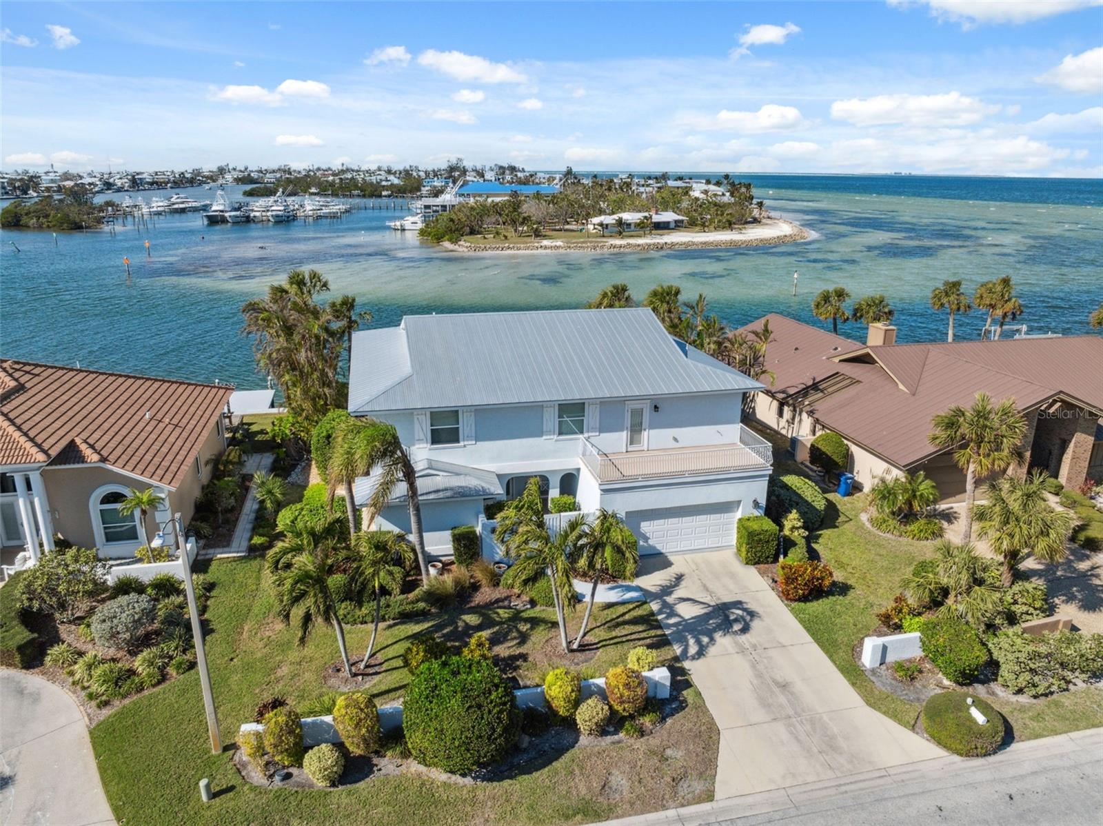 Experience elevated coastal living in the exclusive North Point Harbor community of Holmes Beach, located on the highly desirable northern end of Anna Maria Island. This impeccably maintained custom waterfront estate spans approximately 3,640 square feet and offers direct deep-water access to both the Gulf of Mexico and Tampa Bay from the peaceful shores of Key Royale. Designed with both luxury and functionality in mind, the home features 5 bedrooms, a versatile bonus room, and 6 bathrooms (4 full and 2 half), showcasing timeless craftsmanship and a spacious, thoughtfully designed layout.

Built for lasting quality and refined coastal style, the residence features a durable metal roof, elegant vinyl wood and tile flooring throughout the open living spaces, and two expansive balconies perfectly positioned to capture stunning panoramic water views from nearly every angle. Seller financing may be available, subject to terms.

For boating enthusiasts, the private dock and dedicated boat slip offer effortless, no-bridge access to open Gulf waters and the renowned fishing grounds surrounding Egmont Key — ideal for accommodating a yacht or sportfishing vessel.

Beyond the home itself, enjoy the unmatched lifestyle of Anna Maria Island, celebrated for its charming “Old Florida” atmosphere and strict building limitations that preserve breathtaking views and laid-back island character. This golf-cart-friendly community offers easy access to pristine Gulf beaches, boutique shopping, and exceptional dining along Pine Avenue and Gulf Drive. Key Royale is especially sought after for its quiet, tucked-away setting, private golf club, and serene waterfront surroundings, while North Point Harbor residents also enjoy beautifully maintained grounds and private tennis courts.

Conveniently located just a short drive or boat ride from both Sarasota and St. Petersburg, this property offers the perfect balance of peaceful island living and access to vibrant cultural destinations. Meticulously cared for with no flood damage history, the home is truly move-in ready and maintained to exceptional standards.

Whether entertaining from the chef-inspired kitchen, relaxing on the screened lanai overlooking the pool, or setting out for a sunset cruise from your private dock, this extraordinary property delivers the ultimate blend of coastal sophistication, resort-style comfort, and enduring quality. From its resilient construction to its artisan finishes, every detail has been carefully curated to create a premier waterfront retreat in one of Florida’s most coveted island destinations. Embrace the Anna Maria Island lifestyle — where every sunset feels unforgettable and the water is always just steps away.