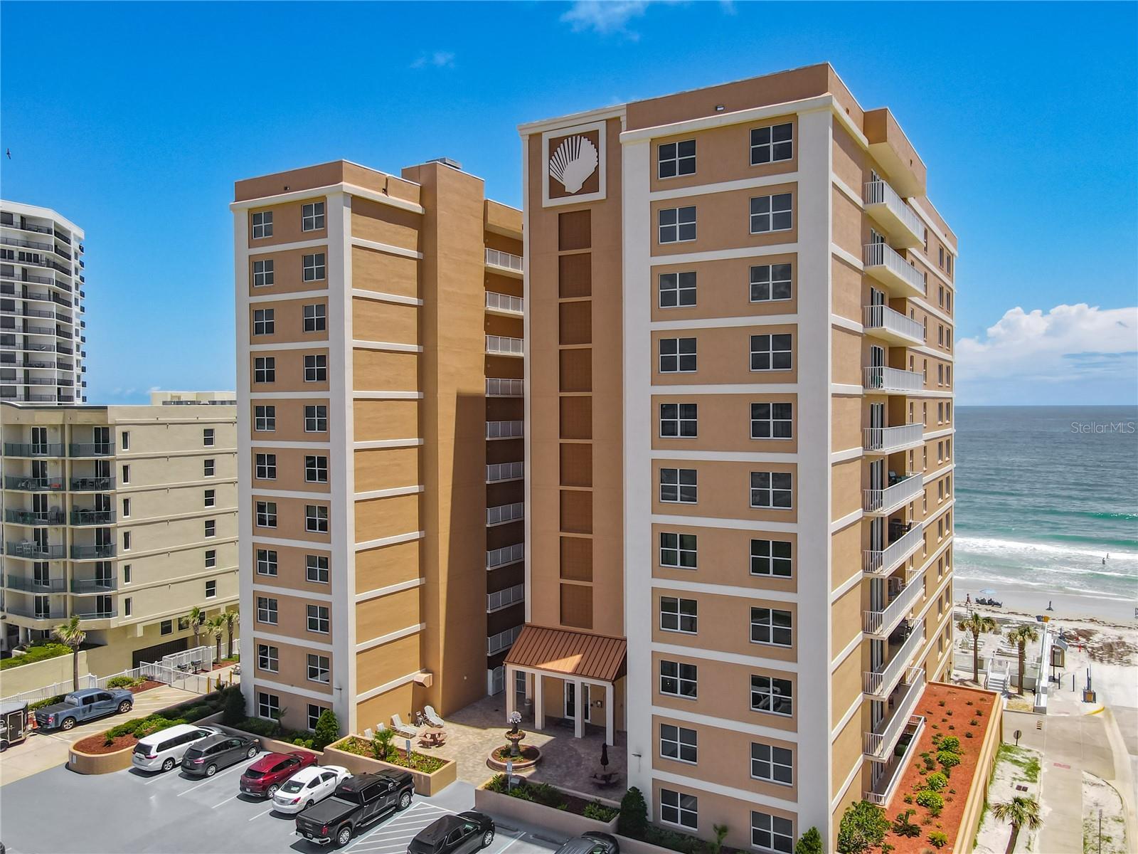 Experience the ultimate coastal lifestyle in this spectacular 3-bedroom, 2-bathroom condo offering breathtaking, dual-water views of both the Atlantic Ocean and the river! Designed for seamless entertaining, the bright, open-concept living area features pristine tile flooring, modern recessed lighting, and a gourmet kitchen complete with premium granite countertops, rich wood cabinetry, and stainless steel appliances. Retreat to the private oceanfront master suite, boasting durable laminate flooring, a generous walk-in closet, and a spa-like en suite bathroom with a Jacuzzi-style jetted tub and separate tiled shower. Step out onto your expansive 18' x 8' tiled balcony to soak in the ocean breezes, fully secured with premium hurricane shutters for ultimate peace of mind.
This pristine building features on-site management and resort-style amenities, including secured underground parking, a fitness weight room, a heated community pool with direct beach access, and a vibrant clubhouse equipped with a pool table and kitchen area. Perfectly situated just steps from the peaceful no-drive beach zone and excellent local restaurants, you are also just an hour away from world-class Orlando attractions. Best of all, short-term rentals are allowed, offering a phenomenal opportunity for lucrative rental income. Whether you are looking for a luxurious primary residence, a vacation getaway, or an investment powerhouse, this seaside paradise delivers it all!
