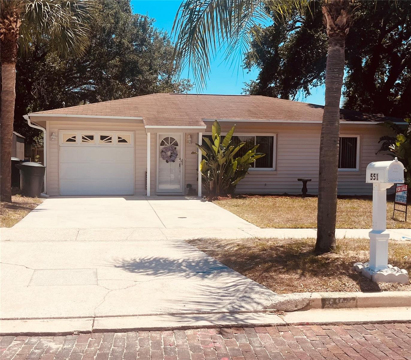 MOTIVATED SELLER. Situated in quiet, established Old Dunedin neighborhood near the Pinellas Trail & Edgewater Drive on the water, featuring mature landscaping. This 2 BDR/1BATH highly desired Dunedin Bungalow/Cottage has been renovated with modern amenities while maintaining its 1950s charm, and it is located in a high-ground area. X Flood Zone. Pride of Ownership in every detail. This Owner has lived in and loved this home for 31 years. 2023 hot water tank. Can be left furnished. 14 inches of insulation blown into attic. The carport has been converted into a single garage with a garage door opener, and also a double driveway!! There is a man door to the outside and also a door connecting to the home through the kitchen!Dishwasher is brand new! Five burner oven!! With a warming plate! Windows have been replaced with double pane windows. Wait until you see your beautiful fenced in backyard that comes with a shed, a freshly stained wooden deck and a freshly painted concrete pad! New Man door installed on garage to large/fenced back yard! Beautiful old rose bushes that the Owner wishes she could take with her! The MODERN kitchen has been beautifully remodeled with  built-to-ceiling from maple, painted white cabinets AND a GORGEOUS BLACK Waterfall Corian countertop! Stainless steel appliances. Soft closed drawers. Kitty corner cabinets. You have a Dining area in kitchen! No popcorn ceilings, all have been done beautifully, and everything is freshly painted! NEW washer and BIG dryer in separate laundry room an garage with a window for fresh air circulation! There are sliders from the kitchen onto your large deck. Both fans have remote control controls and the second bedroom has a Voisin fan with light! Cedar closets! Plenty of windows for letting in our beautiful natural light sunshine in Florida! Full Murphy bed and second bedroom. Built-in linen cupboard in second bedroom. It also comes with a dimmer and different luminescence settings.  Vinyl siding, so you never have to repaint! Waterproof vinyl planking throughout. Ceramic tile in both bedrooms! Front door has been replaced and also a new lock and handle and new exterior lighting outside your front door!  All doors throughout have lever door handles and rocker light switches!! All interior doors have been replaced! Cinderblock home AND NO FLOOD ZONE make this SOLID home even more desirable!! Half mile to Edgewater Drive overlooking the intracoastal Waters in Saint Joseph sound! Two blocks from the Pinellas Trail. MOTIVATED SELLER.