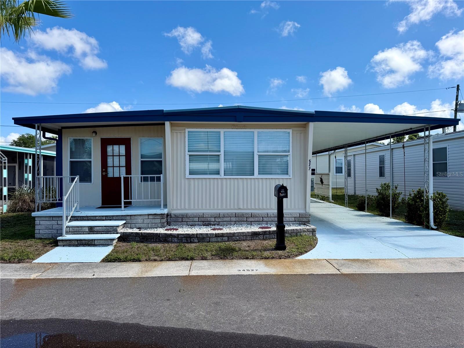 This Community was rated top 5 retirement communities for 2025!  Must see the inside of this home! Very light and bright, very up to date furniture, and has been beautifully renovated/updated! List price includes the Share (valued at $55,000). This home shows pride of ownership for sure! Don’t let the fact that it is a single wide scare you, It has an add-on which features 2 rooms, 1 a bonus room with a pull-out bed, and the other a is set up as a bedroom/NO closet. The primary bedroom has an updated 1/2 bath, most of the floors have been redone with Laminate and/or vinyl planking, other than the ADD-on rooms which have carpet. Kitchen has been fully renovated with beautiful countertops/wood cabinetry/island with the Lazy Susan… and 2 bar stools for light dining…. AND a dishwasher! The owner has added 2 Mini split units (heating and AC), central air is still fully functional. The windows are all NEWER DOUBLE PANE WINDOWS with blinds and/or drapes. The home comes turnkey, fully furnished with the seller only taken a few personal items and their clothing, even leaving the dishes and linens. Sunset Palms is in close proximity to the beaches, airports, I – 275, churches, restaurants all kinds of shopping, etc.… Sunset Palms was voted in the TOP 5 retirement communities for 2025! Inexpensive living at only $210 per month which includes all the amenities one could want; owned clubhouse, escrows are fully funded, beautiful heated pool and spa, fitness center, library, shuffleboard, billiard table, and a small lake at the back of the park, laundry room, and your very own private entrance to the super Walmart… On foot, bicycle or golf cart… Etc., etc.