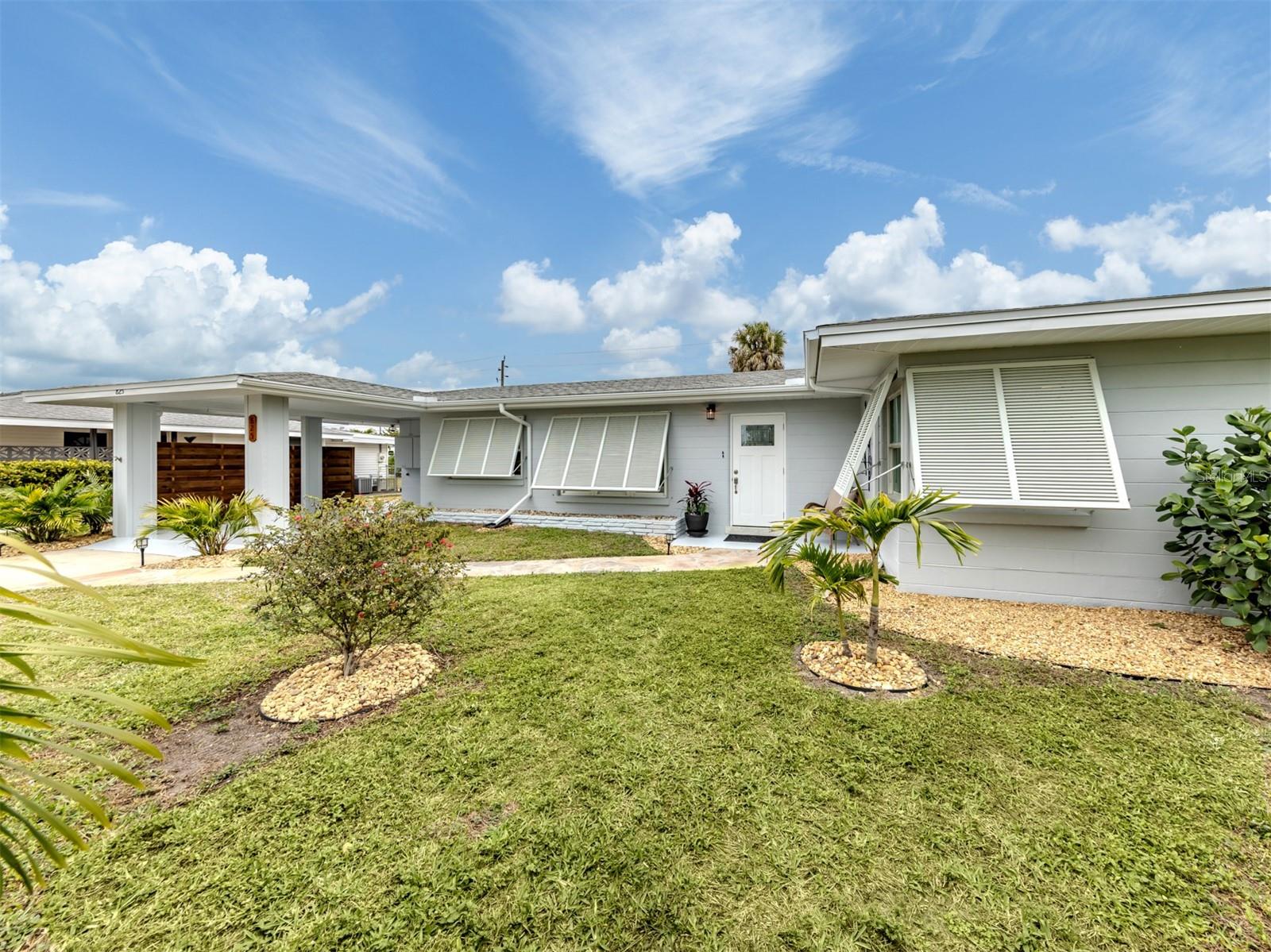 To see it is to love it! You'll be amazed by this Venice Island fully renovated mid-century home, from perfected terrazzo floors, the large contemporary kitchen, open Florida room, the sleek, updated baths, and beautiful private pool and back yard. Located is approx 6 blocks to downtown and 5 blocks to the beach! The list of thoughtful updates is extensive. In the kitchen you'll notice soft-close extra-height cabinetry, a recent suite of appliances, stainless sink that's integrated into the white stone countertops and open pass-thru to the Florida room. Bedrooms are on opposite ends of the house, with amazingly updated bath in between and equally luxurious half bath in the primary bedroom. You'll feel drawn to the large free-form pool, pergola-style patio, tropical plantings and privacy fence enclosing both sides and the back of the property. And beyond just looking good, the roof and AC were recently replaced, house re-piped in 2024, exterior freshly painted in 2026 and windows and most doors are impact rated. The 8x12 combination laundry and workshop just off the carport serves well for extra storage space too. The property is in FEMA X zone, for lowest flood risk. It's classic Venice vintage with modern functional flair. Please plan to see this treasure in person soon!