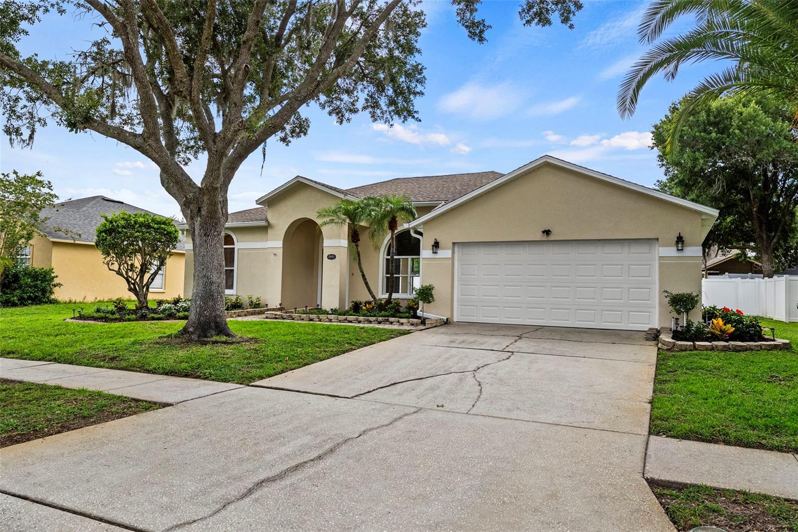 Welcome to this beautifully updated 4-bedroom, 2-bath home in the highly desirable Wyndham Lakes community of Odessa. Offering approximately 1,980 square feet of thoughtfully renovated living space, this move-in-ready residence combines modern style, comfort, and peace of mind with extensive improvements throughout.

Step inside to discover wide-plank pecan luxury vinyl flooring, fresh interior and exterior paint, updated lighting fixtures, new hardware, and new window and door coverings throughout the home. The stunning kitchen has been completely remodeled and features 42-inch shaker cabinetry, under-cabinet lighting, and a full suite of brand-new appliances, including the refrigerator, range, dishwasher, microwave, washer, and dryer.

The spacious primary suite offers a private retreat with elegant French doors opening directly to the covered lanai, a large walk-in closet, and a beautifully updated ensuite bath featuring a double-sink vanity, modern fixtures, and frameless glass shower doors. The secondary bathroom has also been tastefully renovated with stylish finishes and fixtures.

Major updates provide exceptional value and confidence, including a new roof (2022), HVAC system (2020), smoke and carbon monoxide detectors (2026), hurricane-rated garage door with WiFi-enabled opener (2026), new 6-foot vinyl privacy fence (2026), and new rain gutters (2026).

Additional features include a water softener system, in-ground irrigation, and a covered lanai overlooking a generously sized backyard. With ample room for a future pool, outdoor kitchen, play area, or garden, the backyard offers endless possibilities to create your own private tropical oasis.

Ideally located in sought-after Odessa, Wyndham Lakes offers convenient access to shopping, dining, parks, major commuter routes, and highly rated schools. With extensive updates already completed, this turnkey home is ready for its next owners to move in and enjoy.