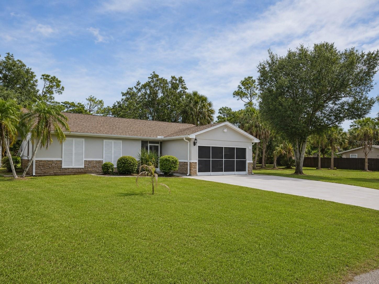 Virtually Staged. WELCOME to your Florida Oasis! This 3 Bedroom, 2 Bath Home with a 2 Car Garage Comes with 3 LOTS! This TRIPLE LOT PROPERTY is a Rare Find, providing you with many opportunities to Expand, Build a Workshop, Garden and Enjoy the Peaceful Park Like Setting. The Lot directly behind the home is cleared and backs up to the street making it easy to access all your Toys, Boat, RV and More. The Lot to the right of the home has also been cleared, while the home itself is on a FENCED LOT which is perfect for your pets. Inside the home you will find an Extra Large Great Room with Built In Book Case/Entertainment Center and High Beamed Ceilings and a Skylight. Kitchen has Plenty of Cabinet Space, Pantry, Double Sink, Recessed Lighting, and Pass thru window to Great Room. Two Sets of French Doors Lead to Screened Lanai and another French Door leads to the Paver Patio, a nice place to Relax.  Primary Suite has Walk in Closet and Ensuite Bathroom. Two Additional Bedrooms and Hall Bath are perfect for Family or Guests.  Home also has Screened, Tiled Entry, Screen for Garage Door, and Plantation Shutters Throughout. No HOA, NO FLOOD ZONE, NEWER ROOF AND AC. FRESHLY PAINTED EXTERIOR AND STUCCO. ALSO COMES WITH  2 SHEDS AND AN EXTRA PARKING PAD. Conveniently Located to Shopping, Dining, Beaches, Boat Ramp, Parks, Sports Stadium, Medical Facilities and More! Don't Miss this Opportunity to Own your Private Piece of Paradise!