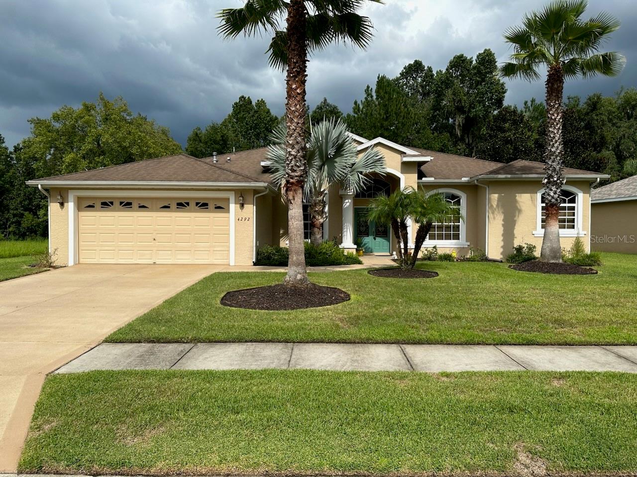 This gorgeous 3 bedroom 2 bath split bedroom home is meticulously maintained and shows like new.  The numerous niches are abundant for personalizing your special spaces.  The open floor plan is inviting and spacious with a view from the living room and bedrooms of the screened lanai for family enjoyment throughout the year.  Woods back the home for complete privacy.  This home was built in 2006 and boasts tasteful and mature landscaping.  The home invites you to step in the double doors, relax and call this house your home!