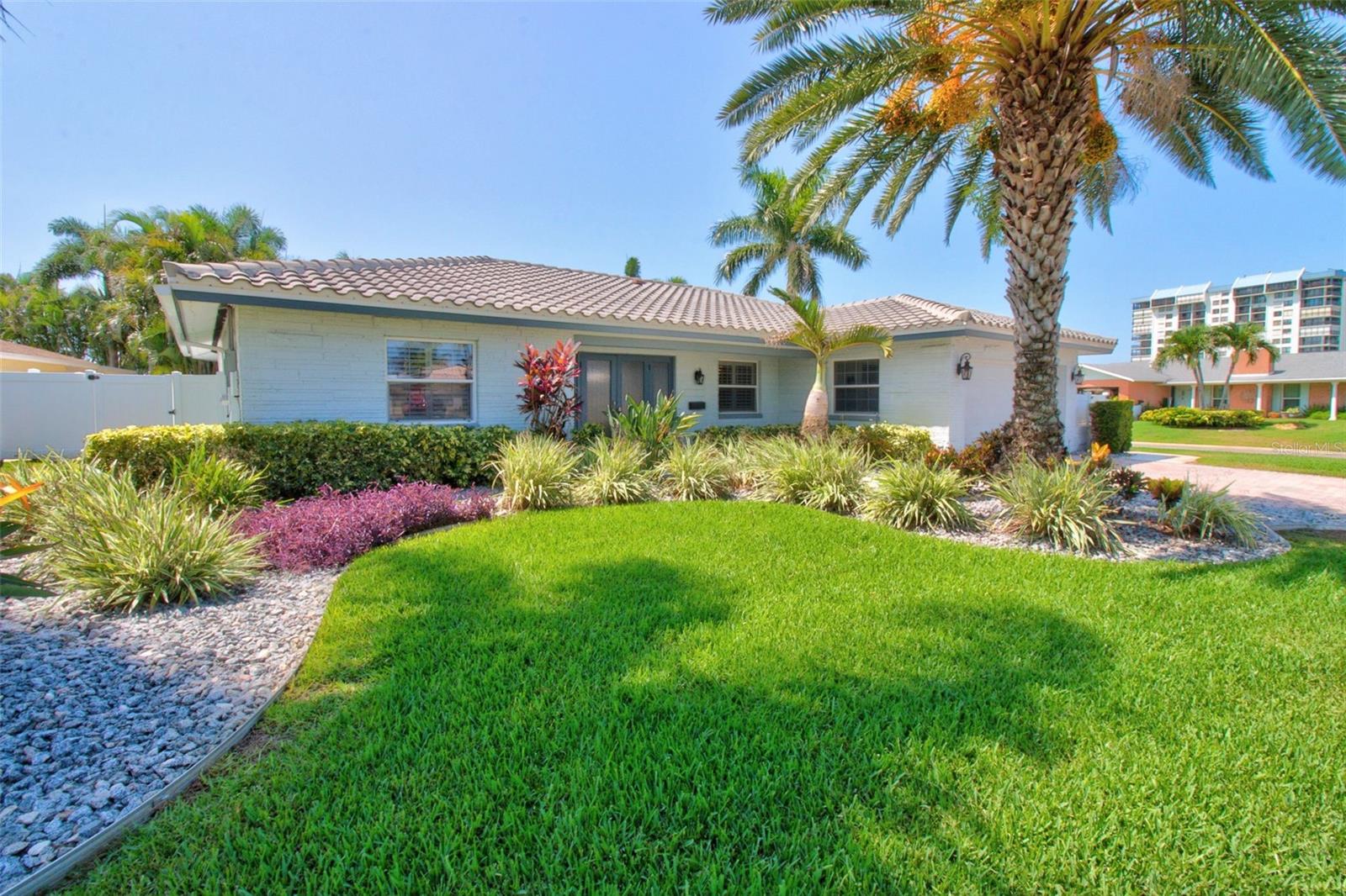 Peace of mind meets the ultimate Florida lifestyle! This beautiful 4-bedroom, 2-bath corner lot home remained high and dry with no flooding during the recent hurricanes and offers the added benefit of underground electrical lines. Beautifully maintained and featuring a timeless tile roof, this home is designed for both comfort and coastal living. The oversized garage includes a dedicated Tesla EV charging station, perfect for modern convenience. Step into your own private tropical retreat featuring a gorgeous pool, lush landscaping, a fully fenced backyard with durable vinyl fencing, and low-maintenance artificial turf—creating the perfect space for entertaining, relaxing, and enjoying the Florida sunshine. Enjoy the best of location and lifestyle: just 5 minutes to the Gulf beaches, a Community boat club for boating enthusiasts, a golf cart-friendly neighborhood, 10 minutes to vibrant downtown St. Petersburg, and approximately 30 minutes to Tampa International Airport. Yacht Club Estates is more than a neighborhood—it’s a lifestyle. Known for its welcoming community spirit, neighborhood events, and the beloved annual Halloween celebration, this is where neighbors become friends. This is a rare opportunity to own in one of St. Petersburg’s most desirable communities, where safety, convenience, coastal charm, and resort-style living come together.