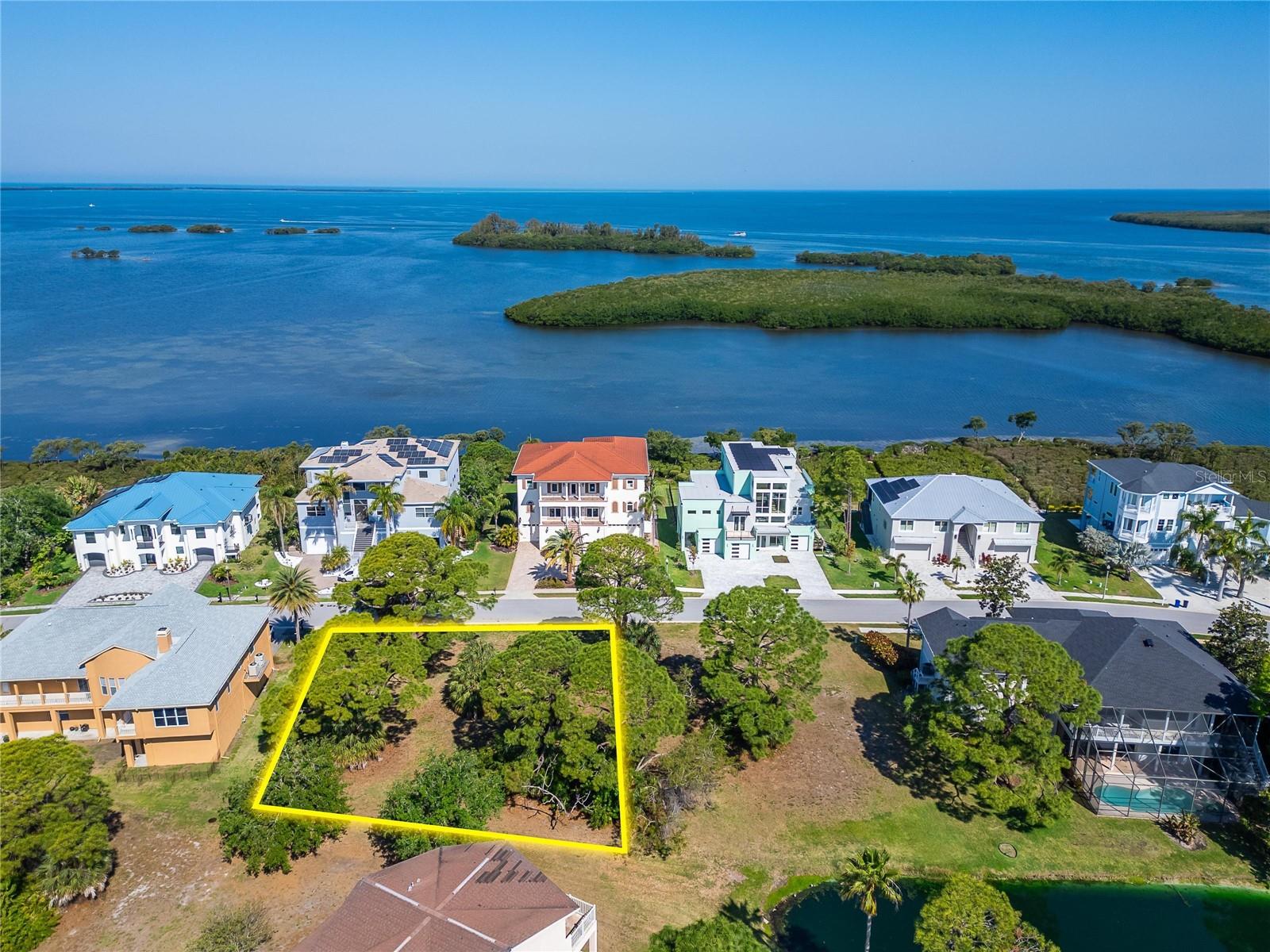 Great opportunity to build in the highly desirable Harbour Watch of Tarpon Springs—a 24-hour guard-gated neighborhood known for its coastal charm and peaceful surroundings.

Lot #124 is a spacious .26-acre homesite featuring tranquil pond views, ideally positioned on a peninsula bordered by the Gulf of Mexico and the Anclote River. This unique setting offers the perfect backdrop to design and build your custom dream home while enjoying privacy and natural beauty.

For those seeking additional space or a larger estate-style footprint, Lots 124 and 125 can be purchased together, creating an exceptional opportunity to expand your vision.

Residents enjoy access to a variety of community amenities, including a clubhouse, resort-style pool, tennis courts, playground, and a waterfront pier with a gazebo—perfect for taking in those iconic Florida sunsets.

The location places you just minutes from some of the area’s most loved destinations, including Fred Howard Park, Sunset Beach, the Pinellas Trail, the Tarpon Springs Sponge Docks, and Downtown Tarpon Springs. From waterfront dining and local boutiques to breweries and cultural attractions, everything you need to enjoy the Florida lifestyle is right nearby.

A rare chance to secure a homesite in one of North Pinellas County’s most scenic waterfront communities—bring your vision and make it your own.