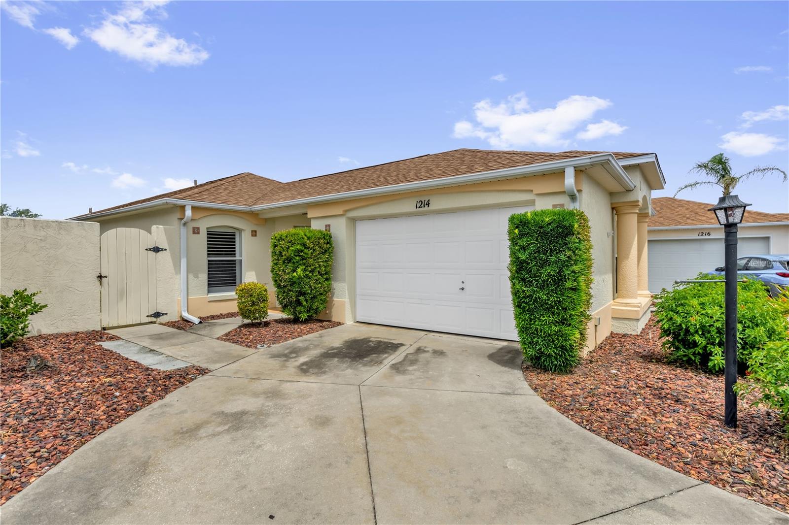 BOND PAID! Rarely available and beautifully maintained, this 2-bedroom, 2-bath block and stucco Beauregard model offers a highly desirable combination of updates, location, and outdoor living. Perfectly situated between Spanish Springs Town Square and Lake Sumter Landing, you'll enjoy convenient access to shopping, dining, entertainment, golf, recreation, and all that The Villages lifestyle has to offer. One of the standout features of this home is the private swimming pool, a rare find in this price range and model. The outdoor space is designed for easy living with low-maintenance landscaping featuring attractive red lava rock throughout the yard. Inside, volume ceilings create a bright and spacious feel, while luxury vinyl flooring extends throughout the main living areas and bedrooms with tile in the wet areas—absolutely no carpet. The kitchen features white bay cabinetry, a skylight that fills the space with natural light, and stainless steel appliances including a glass-top range and French door refrigerator. The interior has been professionally painted and plantation shutters are found throughout the home, providing both style and privacy. Additional features include a digital thermostat, pull-down attic stairs, and a floored attic for valuable additional storage. Even the garage has been enhanced with plantation shutters, reflecting the attention to detail found throughout the property. Major updates provide peace of mind for years to come, including a new roof installed in 2019 and a 2.5-ton 14 SEER heat pump HVAC system installed in 2017. If you're looking for a move-in ready home with a private pool, BOND PAID status, low-maintenance landscaping, and an exceptional central location between the two most popular town squares in The Villages, this home deserves a spot at the top of your list.