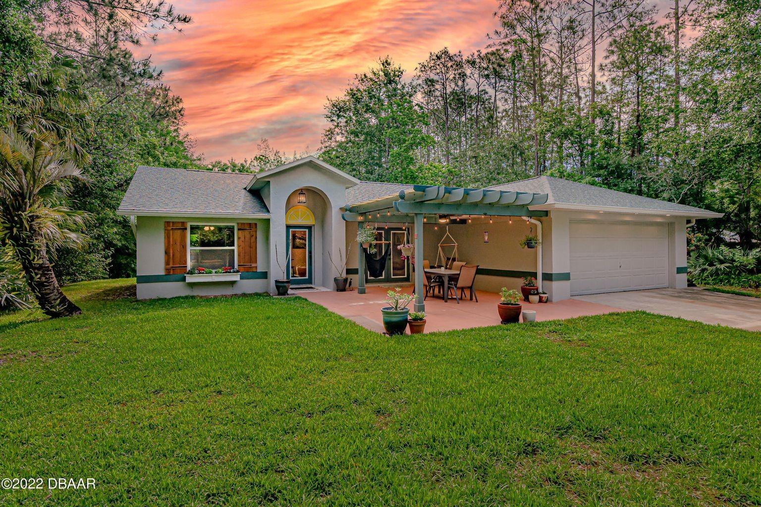 Find peace in country living with this secluded home set on 2.31 acres with easy access to all that Port Orange has to offer. This immaculate home with numerous updates, features a 3-bedroom/2-bathroom/2-car garage, split plan with an updated primary bath and new closet storage sytem. A spacious kitchen with stainless appliances, propane range, cherry cabinet doors, granite countertops and a reverse osmosis water filtration system. New built-in pantry off the dining area with a decorative barn door and eye-catching Pine wood tongue and groove vaulted ceiling in the dining, kitchen and great room. A Wi-Fi ceiling fan in the great room, Nest thermostat and Ring doorbell. Outside includes a three-stall pole building, three raised garden beds, a new shed and fencing with easy lock gates.

Some important updates for this home include a new roof in 2019; exterior paint, new shed, custom closet in primary bedroom and kitchen pantry in 2020; inside there was replacement of bathroom vanities, all plumbing (fixtures and toilets), water filtration, outside gutters, irrigation controller with addition of two sprinklers and garden soaker hoses, water filtration replaced, hot water heater in 2021. Fenced garden featuring raised beds, irrigation and Travertine stepping stones were added in 2022. Transferable Termite Bond with fee. All information deemed reliable but cannot be guaranteed.