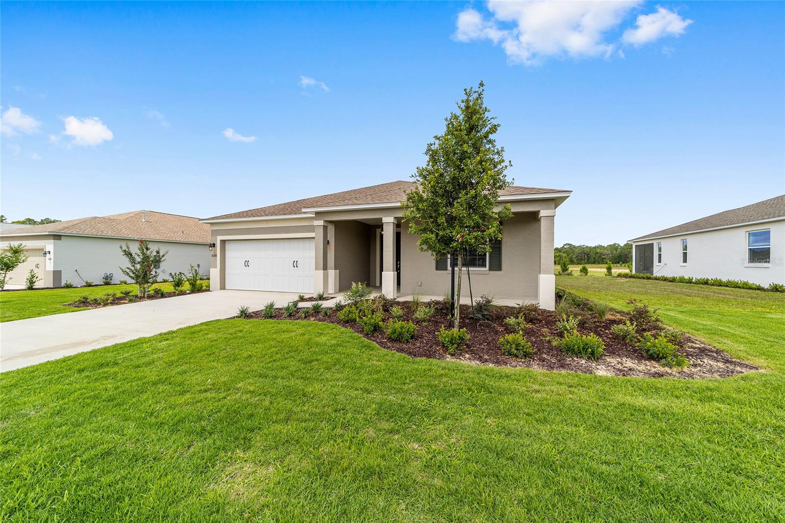 Welcome to this move-in ready Ginger model, where modern design meets effortless, low-maintenance living. Offering 2 bedrooms, 2 bathrooms, a 2-car garage, and a versatile flex room, this thoughtfully designed home provides the perfect balance of comfort and functionality. Luxury vinyl plank flooring flows throughout the entire home, creating a stylish, carpet-free interior. The open-concept great room serves as the heart of the home, seamlessly connecting the living, dining, and kitchen areas for easy entertaining and everyday living. The kitchen is appointed with granite countertops, designer wood cabinetry, and generous storage, while the flex room offers endless possibilities as a home office, hobby room, or additional living space. A dedicated laundry suite adds convenience, and the private primary suite provides a peaceful retreat at the end of the day. Residents of Longleaf Ridge enjoy access to the exceptional amenities and active lifestyle that have made On Top of the World one of Florida's premier 55+ communities, including resort-style pools, fitness centers, golf, pickleball, scenic walking trails, clubs, and year-round activities. Experience the perfect combination of a brand-new home and an award-winning active adult lifestyle.