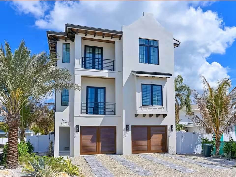 Built to impress and crafted to a caliber rarely seen in today’s island market, this newly completed 4-bedroom, 4.5-bath luxury coastal residence delivers true custom quality at every turn. Built far beyond the standard of an ordinary beach rental or speculative investment property, every inch of this home reflects intentional architectural detail, elevated craftsmanship, and a superior level of construction. A private elevator services all levels, while wide-plank hardwood flooring, extensive custom trim work, rich wood ceiling accents, designer lighting, and expansive black-framed impact windows and doors create a refined yet inviting coastal aesthetic throughout.



At the center of the home, the stunning chef’s kitchen was designed to impress, featuring custom cabinetry, premium quartz countertops, an oversized waterfall island, statement vent hood, premium stainless appliances, designer pendant lighting, and abundant prep and gathering space ideal for effortless entertaining. The adjoining dining area and expansive open great room are flooded with natural light and designed for seamless indoor-outdoor living, opening to multiple covered terraces that create an exceptional flow for hosting family and guests. The primary suite offers a luxurious private retreat complete with balcony access, custom detailing, a spacious walk-in closet, and a spa-inspired bath appointed with dual vanities, a freestanding soaking tub, frameless glass shower, and premium finishes.



Spacious guest suites provide beautifully designed accommodations, while the heated pool, elevated spa, multiple balconies, oversized garage, and spectacular rooftop terrace with panoramic bay views complete the home’s resort-caliber feel. Beyond the walls of this exceptional residence lies the unmatched lifestyle that makes Bradenton Beach and Anna Maria Island one of Florida’s most sought-after coastal destinations. Located just moments from the sugar sand beaches of the Gulf and only a short stroll or golf cart ride to the vibrant shops, waterfront dining, beach bars, live music, and marina activities of iconic Bridge Street, owners will enjoy effortless access to boating, fishing, paddleboarding, sunset walks, and the laid-back luxury of true island living. This is more than a home—it is a rare opportunity to experience the very best of coastal luxury, where every day feels like a permanent vacation.