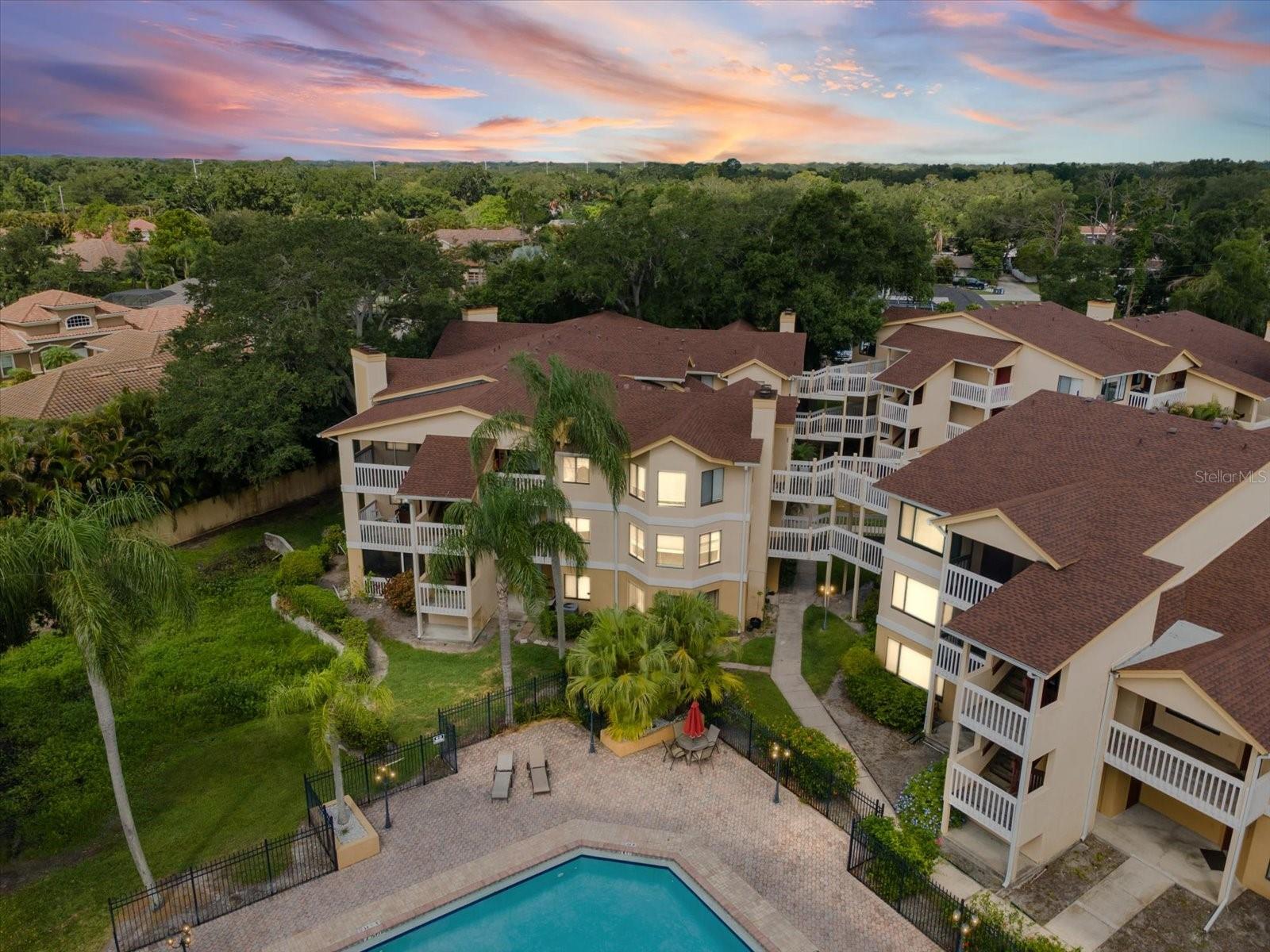 Sunlight pours through the windows of this beautifully maintained 3-bedroom Clearwater condo, where pool views and an abundance of natural light create a welcoming place to call home. Move-in ready and thoughtfully updated, this residence offers the perfect blend of comfort, convenience, and Florida charm.

The open split-bedroom floor plan provides both privacy and functionality, while the spacious living room is lined with windows and anchored by a cozy fireplace, creating an inviting space for relaxing or entertaining. The kitchen offers exceptional storage with 42-inch upper cabinets, a pantry, and a charming eat-in dining area. A full-size washer and dryer are conveniently located inside the unit and are included with the sale.

Privately situated down the hallway, the primary suite features a large walk-in closet and en suite bathroom. Step outside to your covered porch overlooking the pool, the perfect spot to enjoy your morning coffee or unwind at the end of the day. The porch may also be screened in for additional privacy and year-round enjoyment.

Recent updates include a new AC system and water heater, providing peace of mind for years to come. Professionally cleaned and meticulously maintained, this home is truly move-in ready. Just bring your belongings and start enjoying the Florida lifestyle.

Residents enjoy access to resort-style amenities including a sparkling pool, hot tub, fitness center, sauna, clubhouse, and beautifully landscaped grounds. Condo fees cover exterior maintenance, roof upkeep, grounds maintenance, trash service, clubhouse amenities, and security cameras throughout the community. The home also includes a covered assigned parking space, offering everyday convenience and protection from the elements.

Ideally located in the heart of Clearwater, you'll be close to shopping, restaurants, and everyday conveniences, while just minutes from Eagle Lake Park, golf courses, major airports, and the world-famous sugar sand beaches of Clearwater Beach. Enjoy the ease of maintenance-free living, where exterior upkeep, landscaping, and community amenities are taken care of for you. Spend less time on chores and more time enjoying the beach, relaxing by the pool, and experiencing everything Clearwater has to offer. This is Florida living the way it was meant to be.