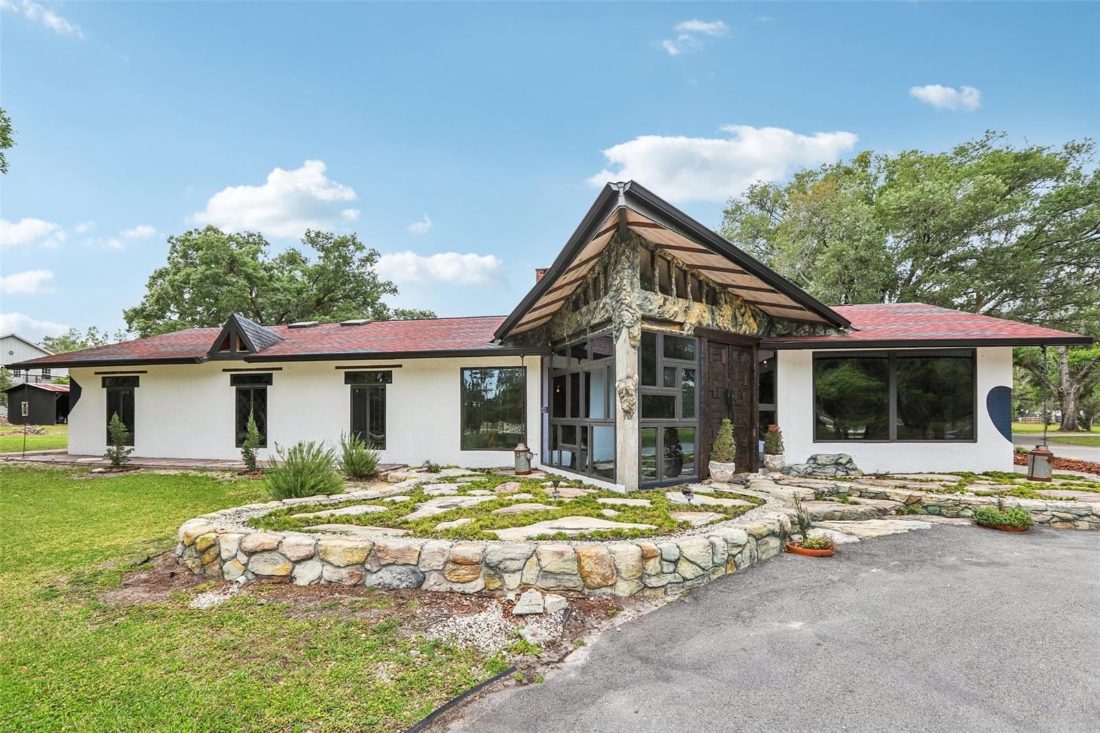 Thoughtfully designed with curated ONE-OF-A-KIND DETAILS.This home radiates a peaceful, zen-like energy, making it a true haven for creatives, nature lovers, and those who appreciate intentional, artful living.
COMPLETELY REMODELED and expanded 2019 to the present. Over built to today’s hurricane standards. No issue with either storm.
2017 Drain fields replaced for septic system 
2019 updates include Well Pump, Well System, Roof (hurricane clips and underlay), HVAC unit and Industrial Ductwork, Garage/Storage
2020 Impact Windows, Master Bedroom and Bathroom, Front Door, TV Room/Family Room
2021 Bathroom fixtures/Skylight, New Kitchen
2023 New Asphalt Driveway, New Barn
2025 Perimeter Fencing
All additions and updates are permitted.
2 private entrances.
Every inch of the home is artfully detailed. Hand painted moldings, All doors are either hand made or imported, as are all the light fixtures.
Many furniture pieces are imported and negotiable. 
Seller is an accomplished artist and most art pieces are available for sale.
Just 30 minutes away from downtown Tampa. 
This area is growing with new construction. Great time to buy!
Near the Lagoon , Tree Hopper and Snow Cap Ridge.
Fun Family area!!