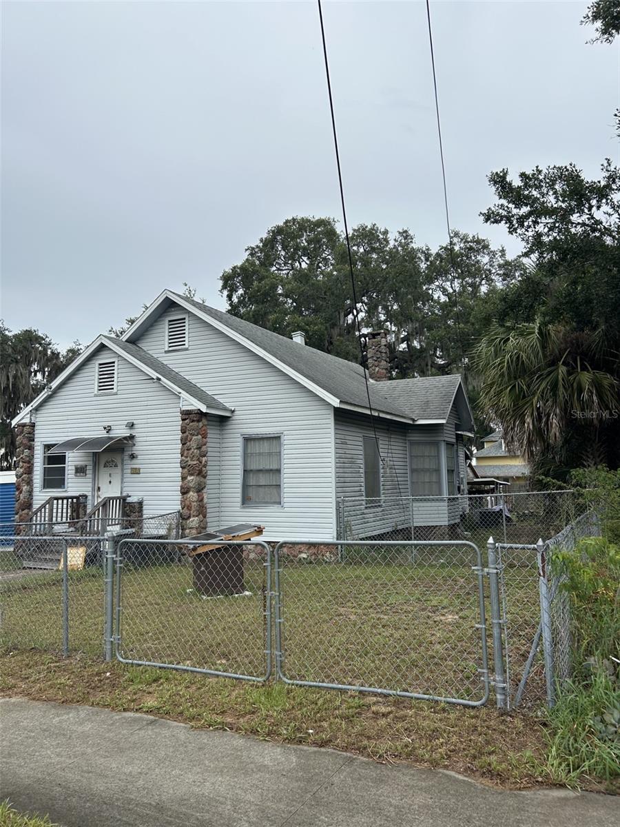 103 E. Ward Ave offers classic Eustis charm with excellent potential for renovation. This 2BD/2BA bungalow features large bedrooms, a wood-burning fireplace, and 2 versatile bonus rooms ideal for a home office, hobby space, or additional storage. The bright layout showcases original character details, and while the home needs updating and some repairs, it provides a strong foundation for buyers looking to customize and add value. The spacious lot with mature landscaping offers room to garden, relax, or expand. Located just blocks from downtown Eustis, Lake Eustis, parks, dining, and community events—perfect for investors, renovators, or anyone seeking a project with upside.