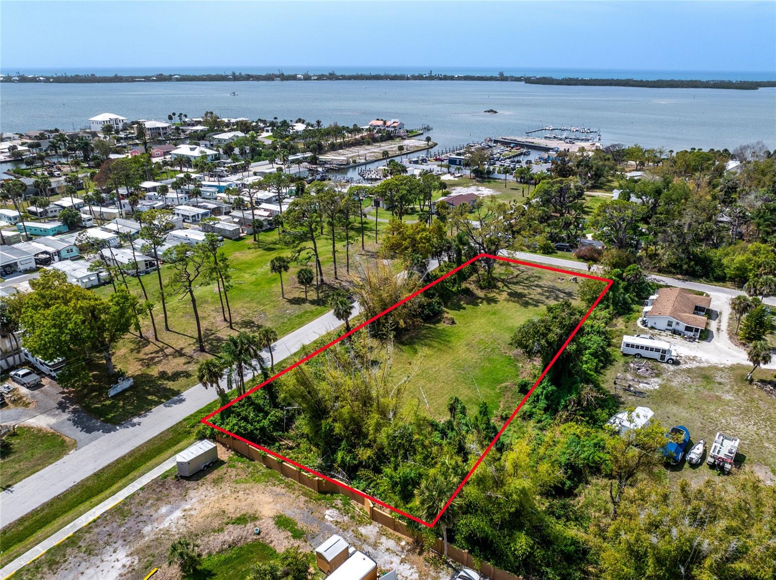 Exceptional and Almost an Acre in the Heart of Old Englewood! Opportunities like this are becoming increasingly rare. This homesite offers an impressive amount of space in one of Englewood’s most desirable and convenient locations. The size of this vacant lot provides flexibility for a spacious primary residence while still leaving room for additional features such as a detached garage, workshop, outdoor living areas, or extra storage for recreational vehicles and boats. The property is surrounded by mature Old Florida vegetation that creates a naturally private setting and a beautiful backdrop for future construction. With RSF3 zoning, there is potential to divide and create multiple homesites, making it an appealing option for builders, investors, or those simply looking to secure a large piece of land close to the water and downtown. Just a few blocks away, Historic Dearborn Street offers a true Old Englewood feel with locally owned restaurants, unique shops, art galleries, and seasonal community events. Nearby marinas, boat ramps, and waterfront parks make it easy to spend time on Lemon Bay, while both Englewood Beach and Manasota Key Beach are only a short drive away. Golf courses, pickleball, medical facilities, and everyday shopping are also conveniently close. A previous home was located on the property, so public water, sewer, and electric service are available, and three existing culvert driveways are already in place to provide convenient access to the property. If you have been searching for a larger homesite with an outstanding location and plenty of flexibility for future plans, this property is well worth a look at Pineapple Ave in Englewood.