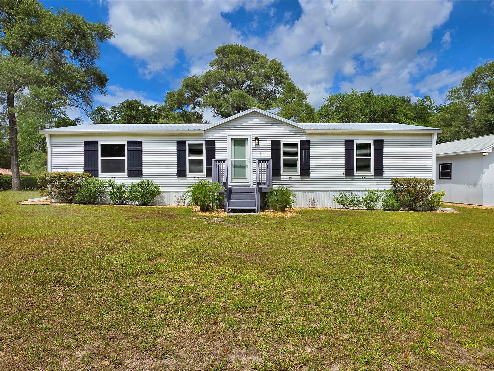 Located in the heart of Lecanto, this charming 3-bedroom, 2-bath manufactured home offers comfort, convenience, and privacy with no HOA or CDD fees. This 1996 build sits on a DOUBLE LOT, totaling just under 1.3 acres. With many recent updates, such as new trim, brocade ceilings, re-textured and painted interior, as well as new windows and a new metal roof, this home is MOVE-IN READY. Additional features include tile flooring throughout, tile countertops in the kitchen, and modern kitchen appliances ready for everyday living and entertaining. 2018 air conditioning system for added peace of mind.
Step outside and enjoy the beautifully manicured yard with mature landscaping and trees, creating a quiet and relaxing outdoor setting. The fully fenced property includes a raised back porch, backyard firepit, and an additional storage shed offering extra space for tools, hobbies, or equipment. Washer and dryer are also included with the sale.
Conveniently located less than one mile from the Suncoast Parkway and under two miles from shopping and everyday essentials, this property combines peaceful neighborhood living with easy access to everything you need. Situated in a non-flood zone, this home is a wonderful opportunity for homeowners seeking value, functionality, and a great location.