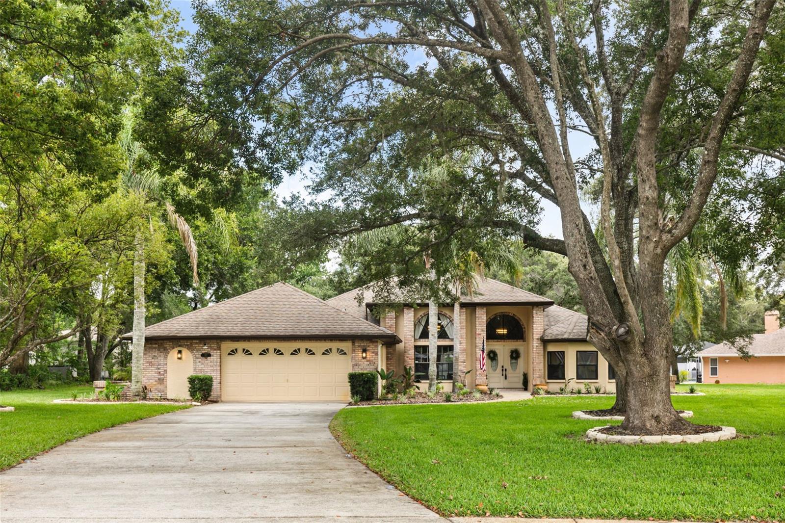 Cookie-cutter? NOT EVEN CLOSE! Introducing 312 Hollow Oak Ct. Redesigned, reimagined, and sure to deliver the WOW factor! Situated on HALF AN ACRE this cul-de-sac lot is in the highly sought-after Preston Hollow community with a LOW HOA ($300/YEAR), this extraordinary 3-bedroom, 2.5-bath pool home is packed with character, charm, and thoughtful design from the moment you arrive. Mature landscaping, timeless brick accents, an OVERSIZED EXTENDED DRIVEWAY, and grand entry with double doors create unforgettable curb appeal. Discover a home that has been completely transformed from floor to ceiling. Featuring SOARING CEILINGS, abundant natural light, designer lighting, UPDATED FLOORING THROUGHOUT, and absolutely NO CARPET, every space has been curated with style and intention. The grand living area is both elegant and inviting, highlighted by a custom accent wall, SLEEK ELECTRIC FIREPLACE, and expansive views of the outdoor living space. An additional sitting area offers flexibility as a formal dining room, reading retreat, or conversation space overlooking the pool and lush landscaping. The oversized galley kitchen is a showpiece, featuring all new cabinetry, QUARTZ COUNTERTOPS, an undermount sink, stunning glass tile backsplash, STAINLESS STEEL APPLIANCES, pantry, tray ceiling, recessed lighting, and a sunny breakfast nook with backyard views. The primary suite is a true retreat, complete with a bay window sitting area, dual closets, and a SPA-INSPIRED BATHROOM THAT RIVALS A LUXURY RESORT. Enjoy oversized marble-look tile, a floating dual vanity, LED mirror, abundant lighting, and an incredible walk-in shower featuring designer inlays, dual rainfall shower heads, and handheld sprays. The secondary bedrooms are generously sized and both offer walk-in closets. The beautifully remodeled guest bath showcases a dual vanity, updated fixtures, stylish tile flooring, and designer finishes. Outside, experience the Florida lifestyle at its finest. A sparkling pool, expansive screened enclosure, and massive covered lanai create the perfect setting for relaxing or entertaining. POCKET SLIDING GLASS DOORS seamlessly blend indoor and outdoor living, making gatherings effortless and memorable. No need to worry about stopping the outdoor fun or tracking water through the house, enjoy the convenience of a private 1/2 bath and outdoor shower at the lanai. Beyond the screen enclosure, enjoy an outdoor firepit area, a TREE SWING, and views of all the mature greenery that surrounds you! The 2 car garage offers an additional space set up for A WORKSHOP WITH BUILT IN SHELVING. Enjoy easy access to Publix, Tampa General Hospital Spring Hill, Suncoast Parkway (SR-589) County Line Rd, US-19, and SR-50 which is booming with new shopping and restaurants! NO CDD FEES, NO FLOOD ZONE. Located in one of the area's most distinctive neighborhoods, where every home offers its own unique personality and charm, this is more than a home, it's a statement. Opportunities like this rarely come along.
