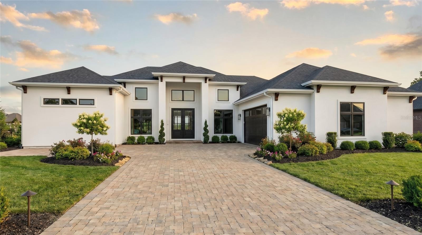 Pre-Construction. To be built. Lakefront Home! Presenting; The Hampton by Trilogy Homes, an architecturally refined lakefront residence designed for elevated everyday living within an exclusive gated luxury home community. Perfectly positioned on Lot 9 a premier homesite offering approximately 82 feet of direct lake frontage, this property enjoys serene water views, enhanced privacy, and a rare connection to natural beauty—creating an extraordinary setting for a custom home of distinction.

Thoughtfully composed and spanning 4,450 sq ft of conditioned living space (over 7,100 sq ft total), The Hampton blends architectural presence with warmth, comfort, and intentional design. Layered natural light, balanced proportions, and seamless indoor–outdoor transitions create a residence that feels both elegant and effortless. The main floor features the primary suite, a grand great room, designer kitchen with an expansive island and walk-in pantry, dedicated dining room, two additional bedrooms, a full bath, powder room, laundry room, and an oversized garage. Covered and uncovered balcony spaces extend the living experience outdoors, capturing elevated lake views and providing exceptional space for relaxation or entertainment.

The lakefront lower level includes two additional bedrooms and a full bath, a powder bath, and a spacious secondary living room with a built-in wet bar—ideal for gatherings, hosting guests, or multigenerational living. Multiple lanai areas provide direct access to the lakeside environment and future poolside living opportunities. A substantial unairconditioned shop and expansive storage areas add meaningful flexibility for hobbies, recreation, or specialty storage needs. Designed with adaptability in mind, Trilogy Homes offers opportunities to personalize The Hampton while maintaining its timeless architectural integrity.

Situated within Mirror Lake, an intimate gated community of just 21 homesites, residents enjoy an uncommon pairing of lakefront serenity and wide-open golf course vistas from the adjacent Clermont National Golf Course. The setting offers privacy, exclusivity, and a lifestyle defined by natural beauty and homes with architectural distinction. This exceptional lot and custom designed home present a rare opportunity to build a luxury residence in one of Central Florida’s most captivating lakefront enclaves, offering privacy, exclusivity, and a thoughtful architectural vision. More than a place to live, Mirror Lake is a retreat for those who appreciate distinction, natural beauty, and a lifestyle designed with intention and differentiation. Close to all things but miles away in Lifestyle, this unique homesite is one of the most captivating sites in Mirror Lake—offering a timeless setting and an extraordinary canvas for your custom home. Call us to reserve this extraordinary lot while you meet with Trilogy Homes to explore this home design further and take next steps to making Mirror Lake your “Dream Home Come True!" There may be additional design fees from the Builder if the offered Home design is materially changed by Buyer.
