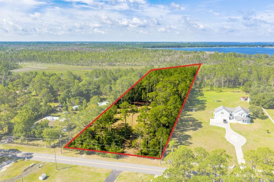 Build your dream home on this scenic 3.84 acre lot! The perfect combination of privacy, nature and convenience as this property backs up to Lake Lizzie Preserve. Located in the Alligator Chain of Lakes, great location with easy access to downtown St. Cloud, Lake Nona/Medical City. No HOA, plenty of space for your RV or boat, or a detached garage. There is a 3,600 square foot elevated pad already in place. Gorgeous setting for a small organic farm or garden. Look no further, bring your builder and build your dream home!!
