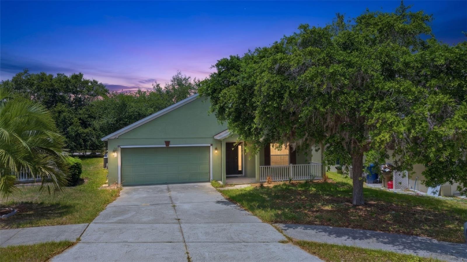 Welcome to this charming single-story home located at 3002 Lorimer Ct in Groveland. Boasting over 1900 square feet of thoughtfully designed living space, this property features 3 bedrooms and 2 bathrooms, making it a perfect retreat for anyone seeking comfort and style.From the moment you arrive, the welcoming front porch and beautifully painted exterior establish a wonderful sense of curb appeal. Step inside to discover a bright, expansive open floor plan illuminated by modern recessed lighting and soaring vaulted ceilings. The primary living spaces are covered in low-maintenance ceramic tile flooring, which effortlessly ties the rooms together.At the heart of the home is a spacious kitchen equipped with crisp cabinetry, stainless steel appliances, a convenient built-in desk area, and a contrasting dark center island that provides excellent prep space. The kitchen overlooks a secondary living area featuring a beautiful soft-blue accent wall, seamlessly connecting to the back patio through sliding glass doors.The primary suite serves as a relaxing oasis, complete with an attached bathroom featuring a double vanity, a dedicated walk-in shower, a built-in closet, and a luxurious corner soaking tub perfect for unwinding. A dedicated indoor laundry room includes built-in storage cabinets and a rustic wood-plank accent wall for added functionality and style. The secondary bathroom is equally well-appointed with a full tub and shower combination. This property beautifully combines style, space, and functionality. Schedule your private tour today to see everything this exceptional Groveland home has to offer.