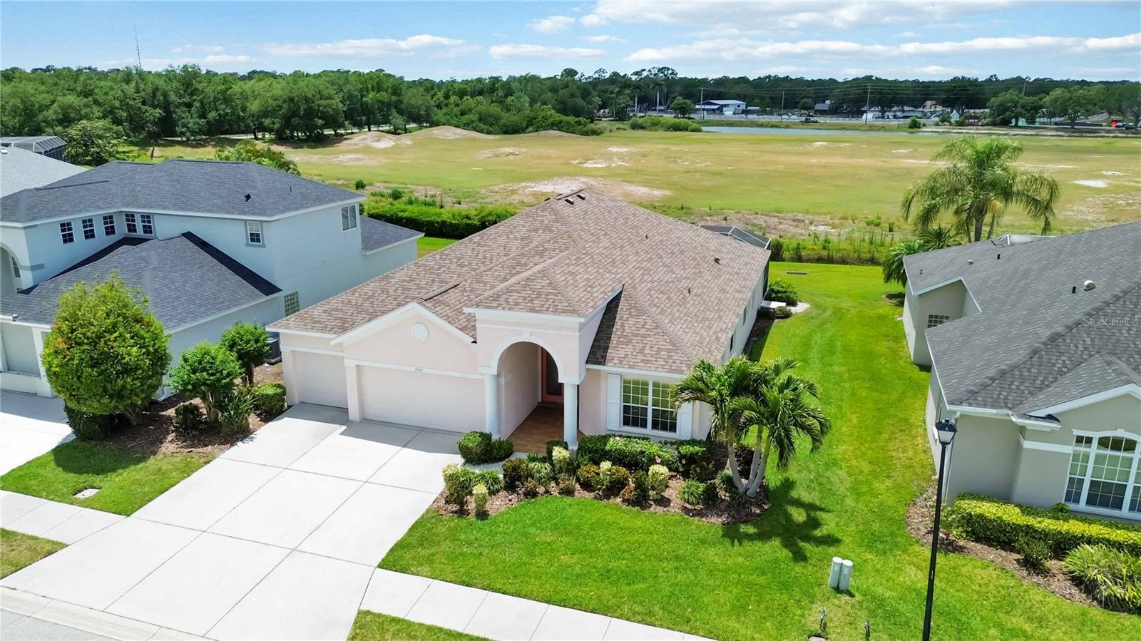 Welcome to 7740 Castleisland Drive, nestled in the prestigious gated enclave of Legends at Tatum Ridge. This three-bedroom plus flex room residence offers a rare combination of elegance and functionality. The flexible room easily serves as a fourth bedroom, while each of the three true bedrooms is en-suite—providing privacy and a sense of distinct “wings” for each occupant. The primary suite is a sanctuary with tray ceilings and direct access to the screened lap pool, letting you step out for a refreshing swim.

With a new roof (2022), new AC (2023), and repiped PEX plumbing (2020), the home is fully updated. The expansive freshly screened pool cage (2022) overlooks the Tatum Ridge Golf Course driving range, offering sweeping views and peaceful privacy. In addition, you will find a 3 car attached garage, a very rare find in this price point!

As you step through the front door, your eyes are drawn straight through the open living area to the sparkling lap pool and the wide open views beyond and from your front porch bask in the gorgeous unobstructed water views directly across the street.  The soaring 12-foot ceilings, luxurious pillars, and walls of glass fill the space with natural light, creating a seamless indoor-outdoor flow. The open concept effortlessly connects a formal dining room and a sunny breakfast nook, perfect for gatherings. Sliding glass doors open right out to the expansive screened pool area, where a convenient pool bath makes outdoor entertaining even more functional. This central hub is the home’s bright, inviting core! 

Location is unbeatable—just under 4 miles to Waterside Place’s vibrant shops and dining, and you’re mere seconds from Fruitville Road, making downtown Sarasota just a 15-minute drive. Quick access to the I-75/Fruitville interchange ensures effortless travel.

The HOA is a standout feature—no CDD, and all yard maintenance is covered, from lawn care to irrigation, for a truly low-maintenance lifestyle. This home is your key to luxurious, worry-free living in the heart of Sarasota’s best and won't last long. Schedule your showing today!