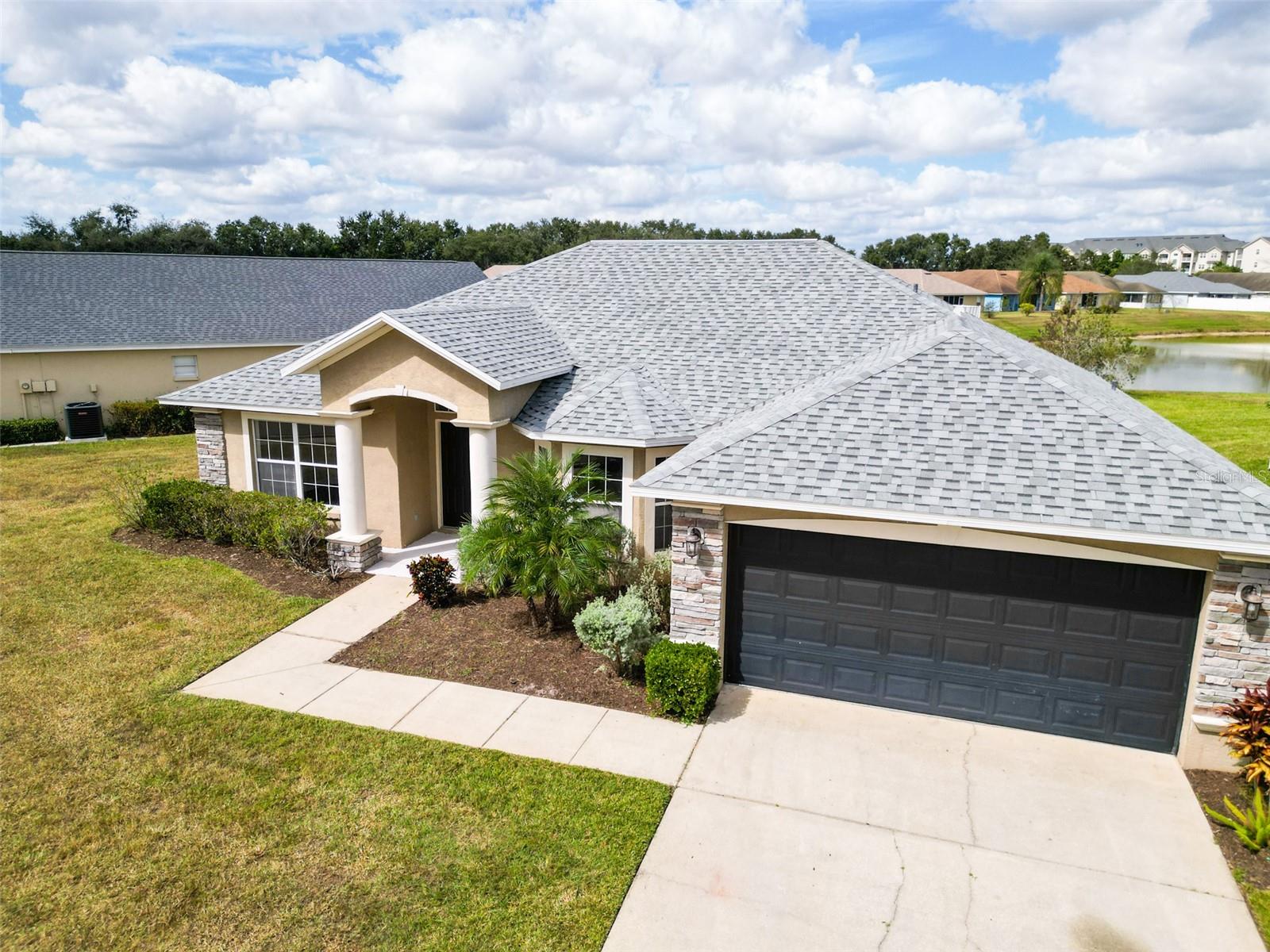 One or more photo(s) has been virtually staged. Prepare to be amazed as you enter this South Lakeland beauty! Nestled in the highly sought after Twin Lakes at Christina GATED community, and zoned for one of Central Florida's top school districts, this home literally has it all! This PRIVATE POOL home is filled with beautiful natural light throughout and has an open, split bedroom floor plan with volume ceilings. This 3 bedroom, 2 bathroom home also features a BONUS ROOM, with can be used as a 4th bedroom, office, den, or formal dining room. The oversized kitchen is every chef's dream, and it has all new stainless steel appliances and a breakfast nook facing a lovely Bay window. Displaying views of the maturely landscaped backyard and tranquil pond, this home sits on an oversized pie-shaped lot that affords privacy and comfort. In addition to the brand-new appliances (2023), this home also features a brand-new ARCHITECTURAL SHINGLE ROOF (September 2023), newer AC (late 2020), and a brand-new pool pump (2023). This home is complete with NO CARPET THROUGHOUT, connected to City sewer, irrigation system, ample 2-car garage and features a beautiful stone elevation. Conveniently located within close proximity to restaurants, grocery stores, shopping, and main highways. This turnkey property is just waiting to be loved by its next owner, schedule your showing today!
