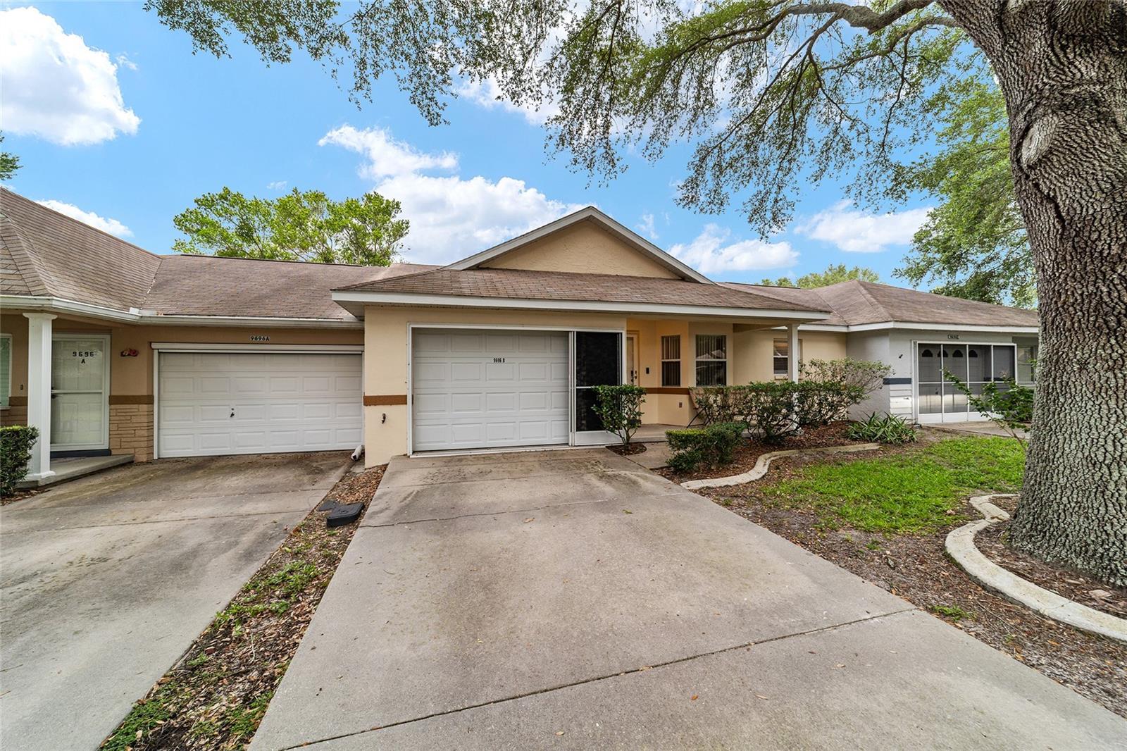 Olympia model with 2 bedrooms and 2 bathrooms located in Crescent Ridge! This well-maintained home features several updates, including luxury vinyl plank flooring, stainless steel appliances, and a newer HVAC system (2021). The spacious living room offers high ceilings, a ceiling fan, and access to the enclosed Florida room, complete with carpet, windows, and a fan for year-round enjoyment. The guest bedroom includes 2 closets, carpet flooring, and a ceiling fan, while the guest bathroom features a single vanity, tub/shower combination with tile surround, and an overhead storage cabinet. Situated on the opposite side of the home for added privacy, the primary suite offers a smart ceiling fan and an ensuite bathroom with a large single vanity, tiled shower, grab bars, linen closet, and additional storage cabinet. Additional highlights include fresh interior paint, a smart thermostat, smart exterior locks, and a washer and dryer located in the garage. This move-in ready home combines comfort, convenience, and thoughtful updates in a desirable Crescent Ridge location. Located in Ocala's premier, gated, active 55+ community, loaded with amenities, including golf cart access to 2 shopping centers.