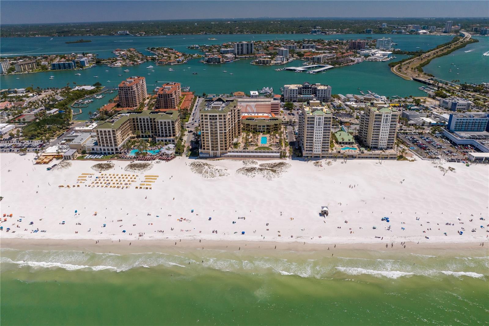 Welcome to the Residences at Sandpearl, the epitome of luxury living on Clearwater Beach. This stunning 4-bedroom, 3.5-bathroom residence boasts over 4,700 square feet of living space and uninterrupted panoramic views of both the Gulf of Mexico and the Intracoastal Waterways.

Step inside and be mesmerized by the open-concept living and dining area, complete with high-end finishes and tons of space for entertaining. The chef's kitchen features top-of-the-line appliances, a breakfast bar, reverse osmosis water filtration to both the refrigerator and the icemaker, and breathtaking views from every angle. The unit also features three large terraces, perfect for watching the sunrise and sunset over the sparking Gulf and Intracoastal waters.

The luxurious primary suite offers a spacious sitting area with built-ins, including two cooled beverage drawers, a spa-like ensuite with double vanities, a jetted tub, a walk-in shower, and 2 walk-in closets. The remaining three bedrooms each have access to a terrace, offering unique and stunning views.

Additional amenities dedicated to this luxurious penthouse unit include 2 assigned under-building parking spaces, climate controlled storage unit, and a beachside cabana perfect for storing all of your beach gear!

Sandpearl Residences is more than just a place to call home. It's a lifestyle, a haven where every detail is designed to provide you with the ultimate in luxury and comfort. The building's exceptional amenities are second to none, ensuring that every day feels like a vacation. From the moment you step inside, you'll be captivated by the stunning architecture, exquisite design, and unparalleled views.

This secure building provides residents with a 24/7 Concierge, gathering rooms, billiards room, conference room, state of the art fitness center, bike storage, whole-building water softener, and a beachside pool with expansive relaxation and entertainment areas. With its perfect location in the heart of Clearwater Beach, you're just steps away from local shopping, fine dining, and the world-famous white sand beaches.

Whether you're looking for a full-time residence or a vacation home, Sandpearl Residences is the perfect choice. This exclusive community is located in one of the most desirable areas of Clearwater Beach, surrounded by breathtaking natural beauty and world-class amenities. Don't miss your chance to own a piece of paradise in this unparalleled oceanfront oasis.