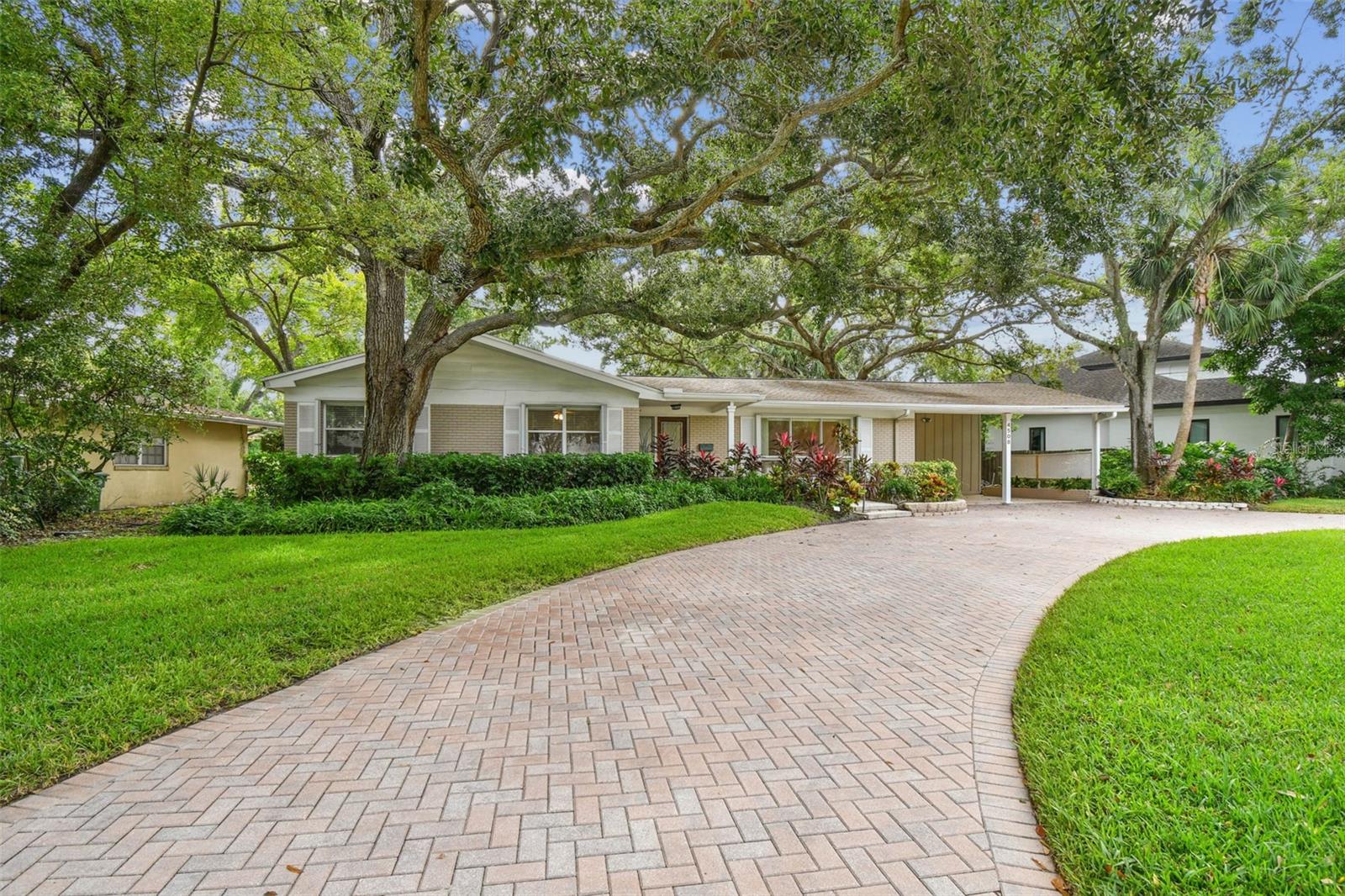 NO TREE ISSUES!! PRICE REDUCTION! Owners have the Arborist report for removal approval so make an offer! 96x156 lot. The existing home is meticulously maintained and had NO damage from last year's hurricanes.  3-bedroom PLUS den,  2-baths,  2,318 square feet and surrounded by million-dollar homes in the heart of desirable Sunset Park. Ideally located near the Westshore Business District and zoned for Mabry, Coleman, and Plant school districts. The home features fresh interior paint, 2024 A/C, 2017 roof, stainless steel appliances, hardwood and tile flooring, and new carpet. The functional floor plan includes separate formal living and dining rooms, plus a generous family room! Perfect for entertaining or everyday living. The cook’s delight kitchen offers a breakfast bar, island with electric and storage, pull-out pantry cabinet, built-in desk, and ample counter space. The primary suite includes a private bath with tub, while the two additional bedrooms share a full bath with shower. Outdoor highlights include a covered front porch, oversized brick-paver circular driveway, 2-car carport with attached utility/storage room, and a huge fenced backyard with a deck that is ideal for gatherings!