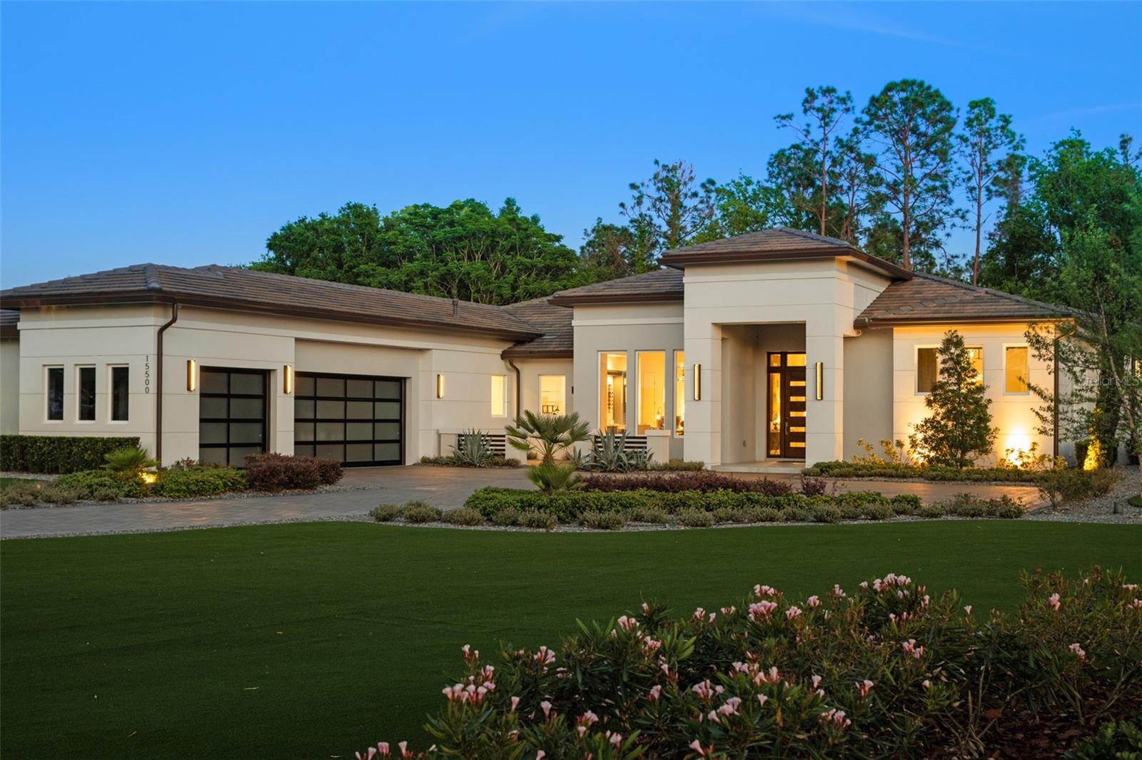 FULLY DECORATED/FURNISHED MODEL LEASEBACK OPPORTUNITY-Experience the pinnacle of modern luxury living in this stunning Bel-Air Model Home, showcasing transitional architecture with sleek contemporary elements. Encompassing 5 bedrooms, 5 bathrooms, and a 3-car garage, this 4,518 sq. ft. residence offers a seamless blend of style, comfort, and advanced technology.

Step through the dramatic 10-foot entry door into a thoughtfully designed interior with 12-foot ceilings, engineered hardwood flooring, and designer finishes throughout. The expansive great room features a three-way glass fireplace and 10-foot pocketing sliding doors that open to the lanai, creating a fluid indoor-outdoor living experience. The gourmet kitchen is a culinary masterpiece, equipped with a full Wolf and Sub-Zero appliance suite, quartz countertops, a pot filler, and custom lighting.

The luxurious primary suite impresses with a seating area, wet coffee bar, showcase closets with glass doors and LED lighting, and a spa-like bath with a freestanding tub and programmable retractable shade. Flexible living spaces include a front bedroom/office with a custom wine built-in, a guest suite with a private porch and kitchenette, and a media/flex room with pool bath access.

Designed for effortless entertaining, the outdoor living space features a modern linear fireplace, a summer kitchen with a waterfall island, and a fully automated heated pool and spa. Additional highlights include a climate-controlled garage with a 10,000-pound car lift, synthetic turf landscaping, a sealed paver driveway, and a $150,000 Crestron smart home automation system controlling lighting, audio, video, security, and climate.

Sold fully furnished with a $125,000 designer package, this turnkey residence offers an unparalleled lifestyle of sophistication, comfort, and cutting-edge innovation. Builder will leaseback the home from the Buyer for a period of one year from the date of closing compensating the Buyer $10,000.00/month. Buyer will be responsible for the annual property taxes during the leaseback period. Seller will pay the club sports membership fees, HOA fees, pool and lawncare, utilities and insurance on the home during the leaseback period.

Located within the gates of Bella Collina, residents enjoy a vibrant year-round calendar of culinary and social events, offering endless opportunities for connection and enjoyment. Golf enthusiasts can tee off on the renowned Nick Faldo-designed championship course, while others can relax on the scenic restaurant terraces. Bella Collina’s world-class amenities include Har-Tru tennis courts, pickleball courts, a luxurious spa, an expansive outdoor pool complex, and a cutting-edge fitness center with complimentary fitness classes. Contact us today to schedule a personal tour of this home and the community. The $40,000 Sports Membership Deposit is Deferred by the Seller.